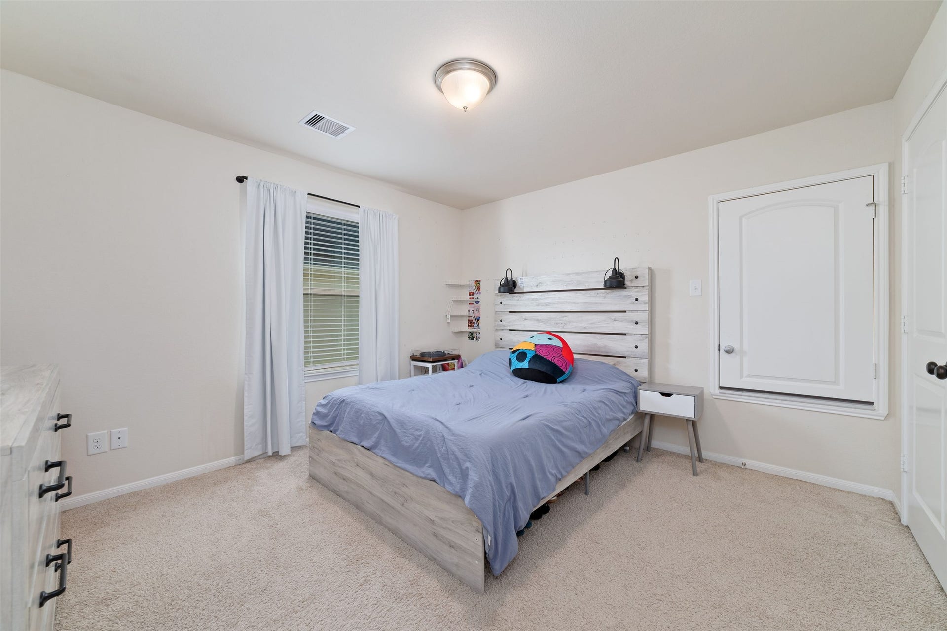 Another generously sized secondary bedroom with natural light and ample space.