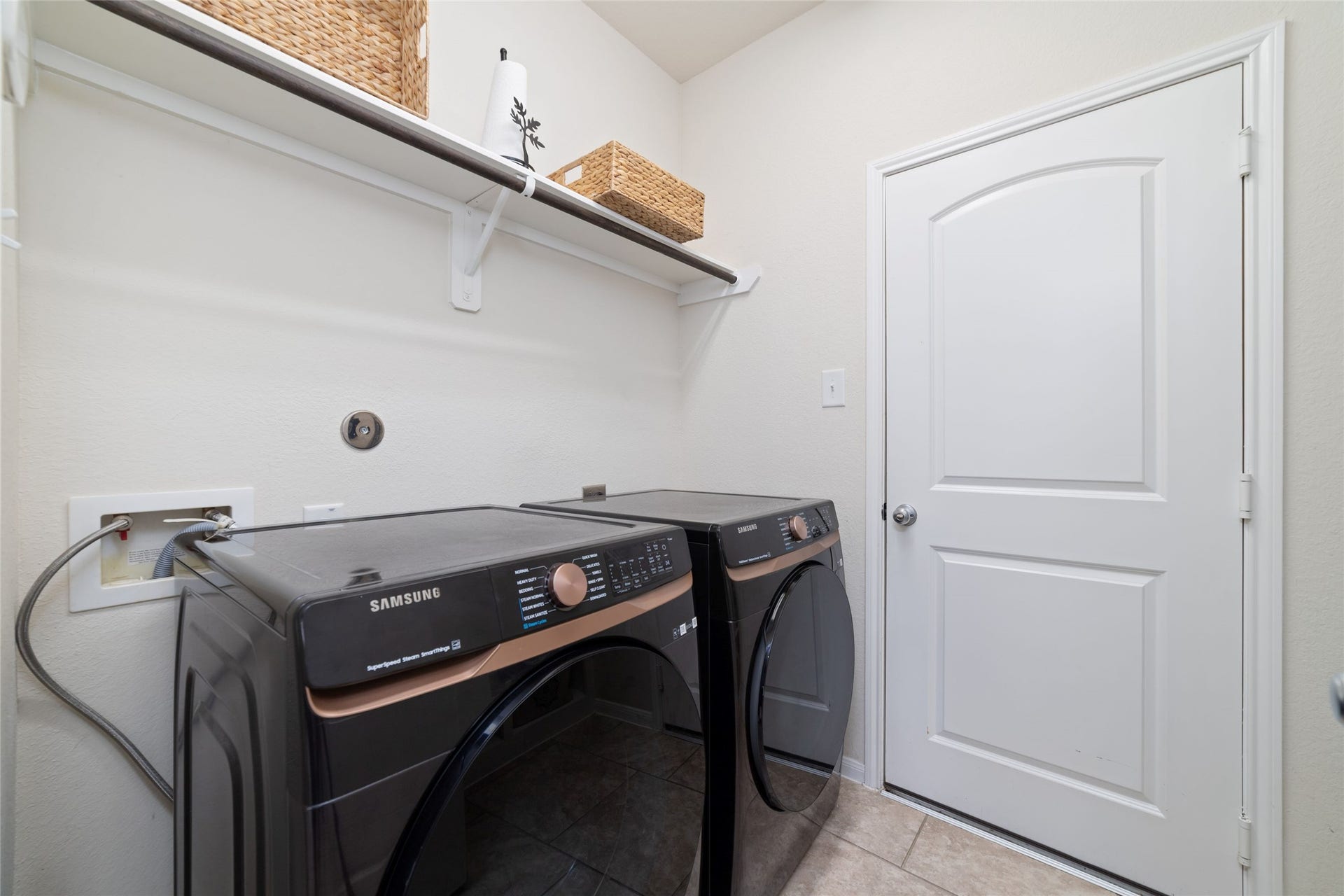 Convenient in house utility room with built-in shelving and additional storage.