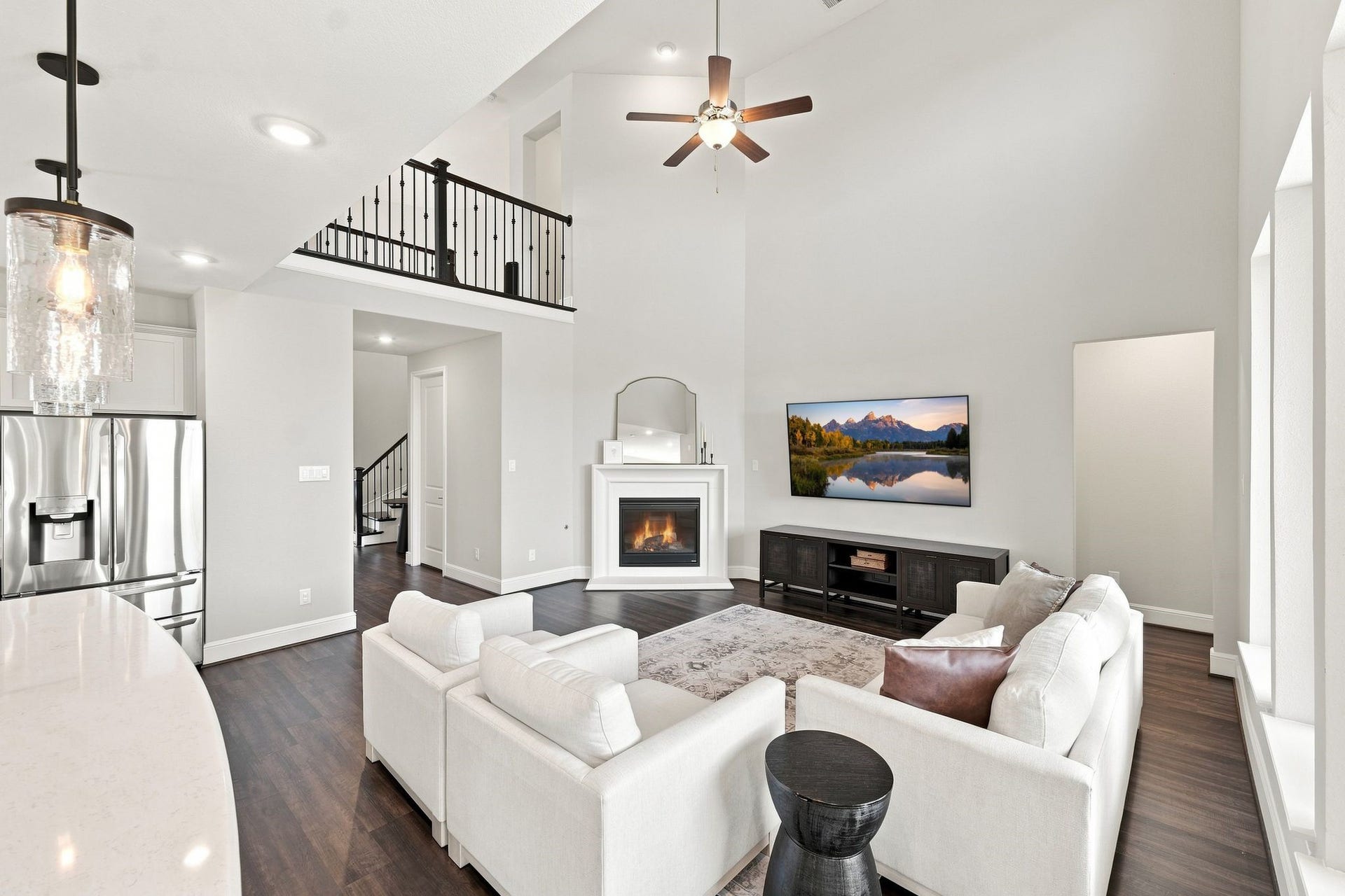 3011 Lantana Trail, Katy, TX 77493 Two-story family room with a full wall of windows and gas fire place with switch start.