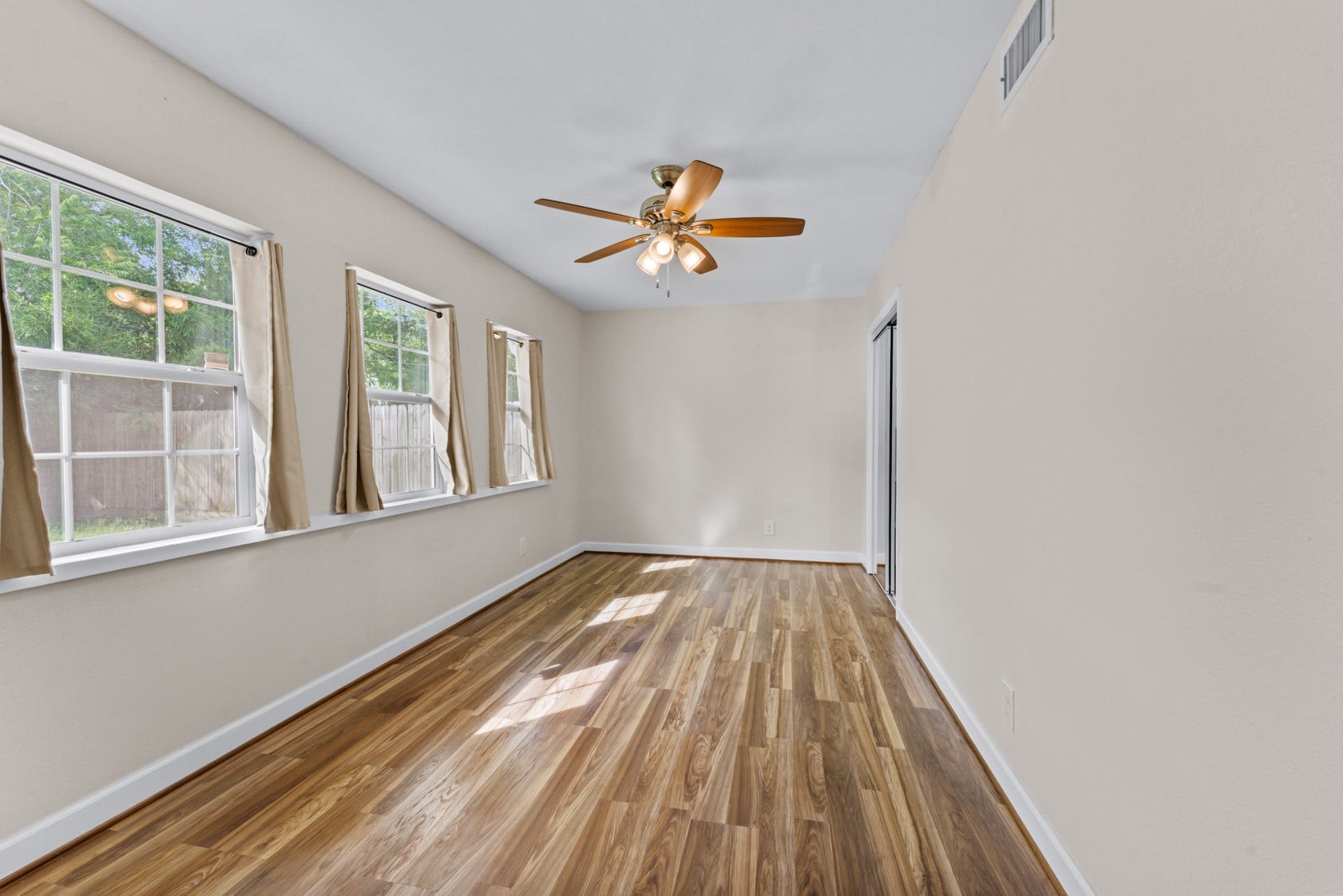 The second guest bedroom has a wall of windows overlooking the big backyard. No back neighbors so this room is very private.
