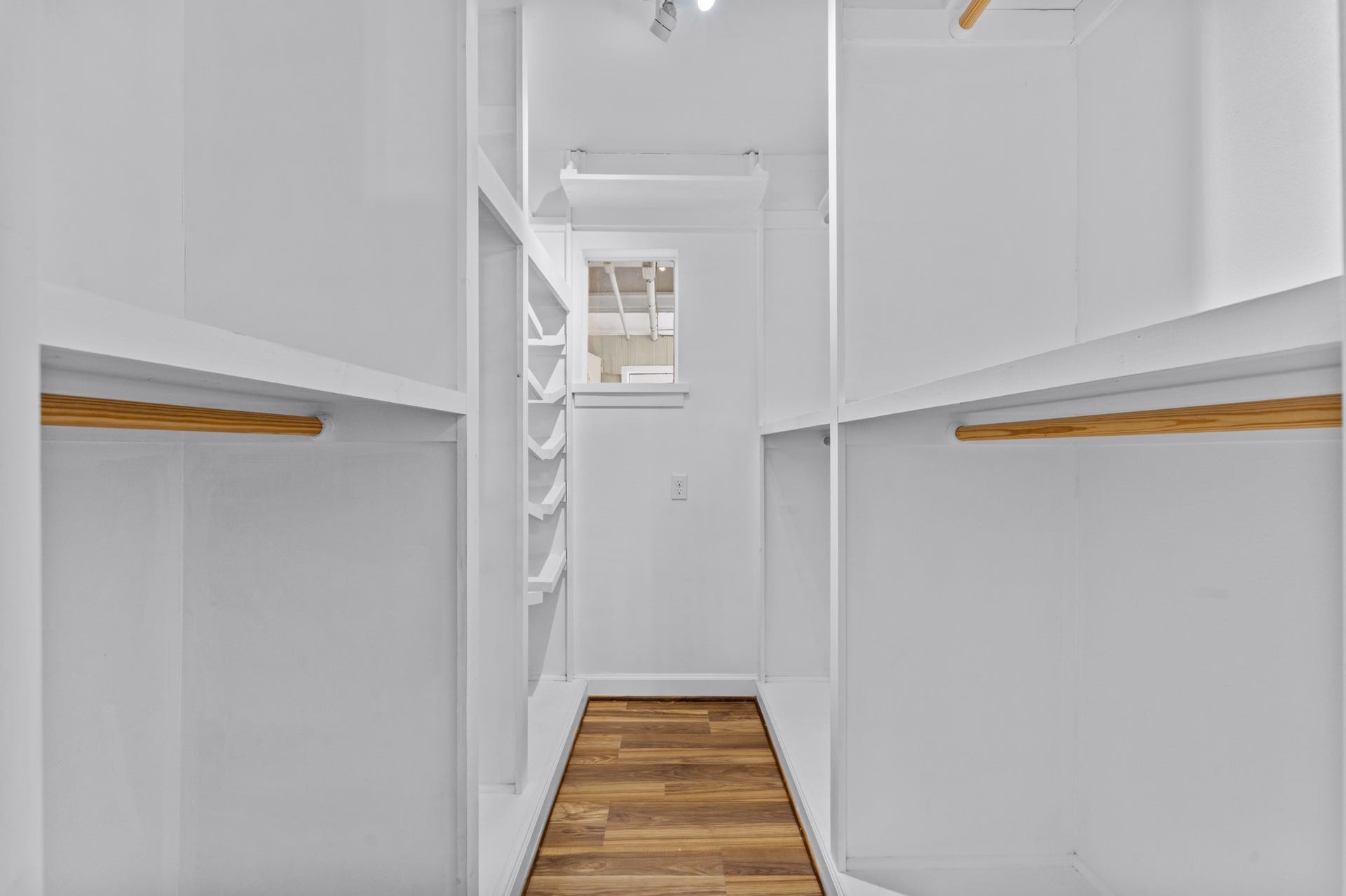 This walk-in closet is the larger of the two closets in the primary suite. Enjoy easy organizing with built in shelves!