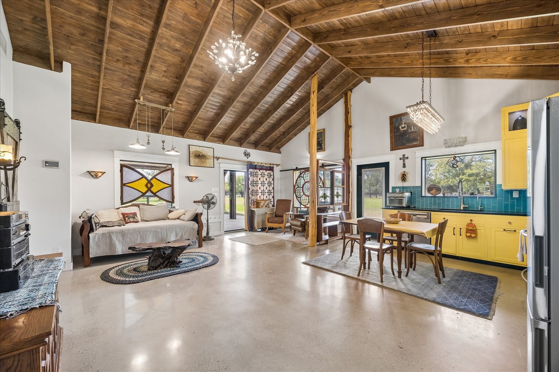 33 Riverwood Lane, Hempstead, TX 77445 Grand cathedral ceiling in the living area with exposed wood beams and stained wood ceiling. Patio doors lead to the covered area outside