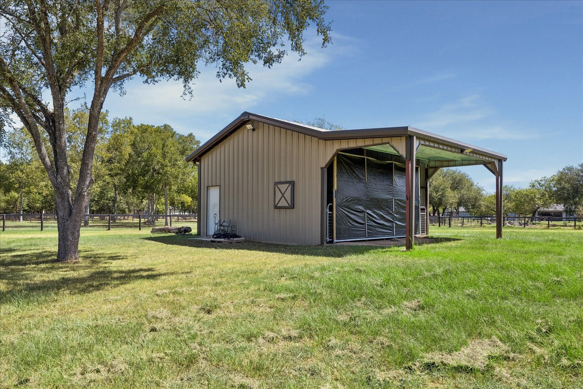 33 Riverwood Lane, Hempstead, TX 77445 24x24 3-Sided Metal Barn with a 10x16 Roll-Up Door and 10x24 Overhang - Great for trailer and equipment storage - Foam insulation on the walls and ceiling