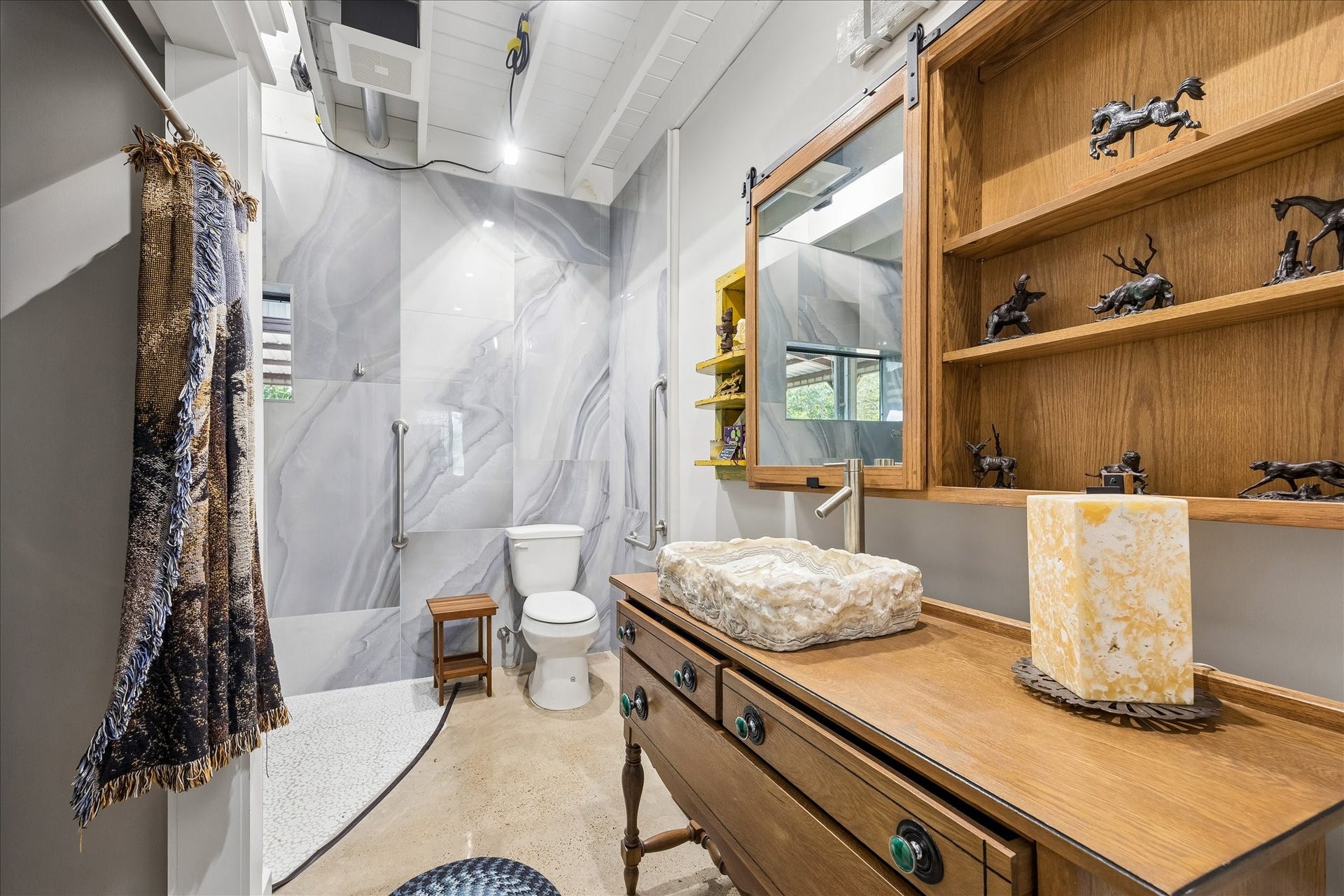 33 Riverwood Lane, Hempstead, TX 77445 Primary bath with an repurposed antique cabinet with a natural stone sink and large walk in shower
