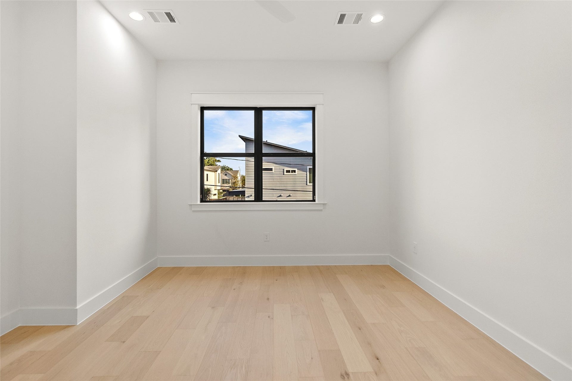 Natural light fills your second secondary bedroom, creating a comfortable space that's ready to become your guest room, second office, or creative space.