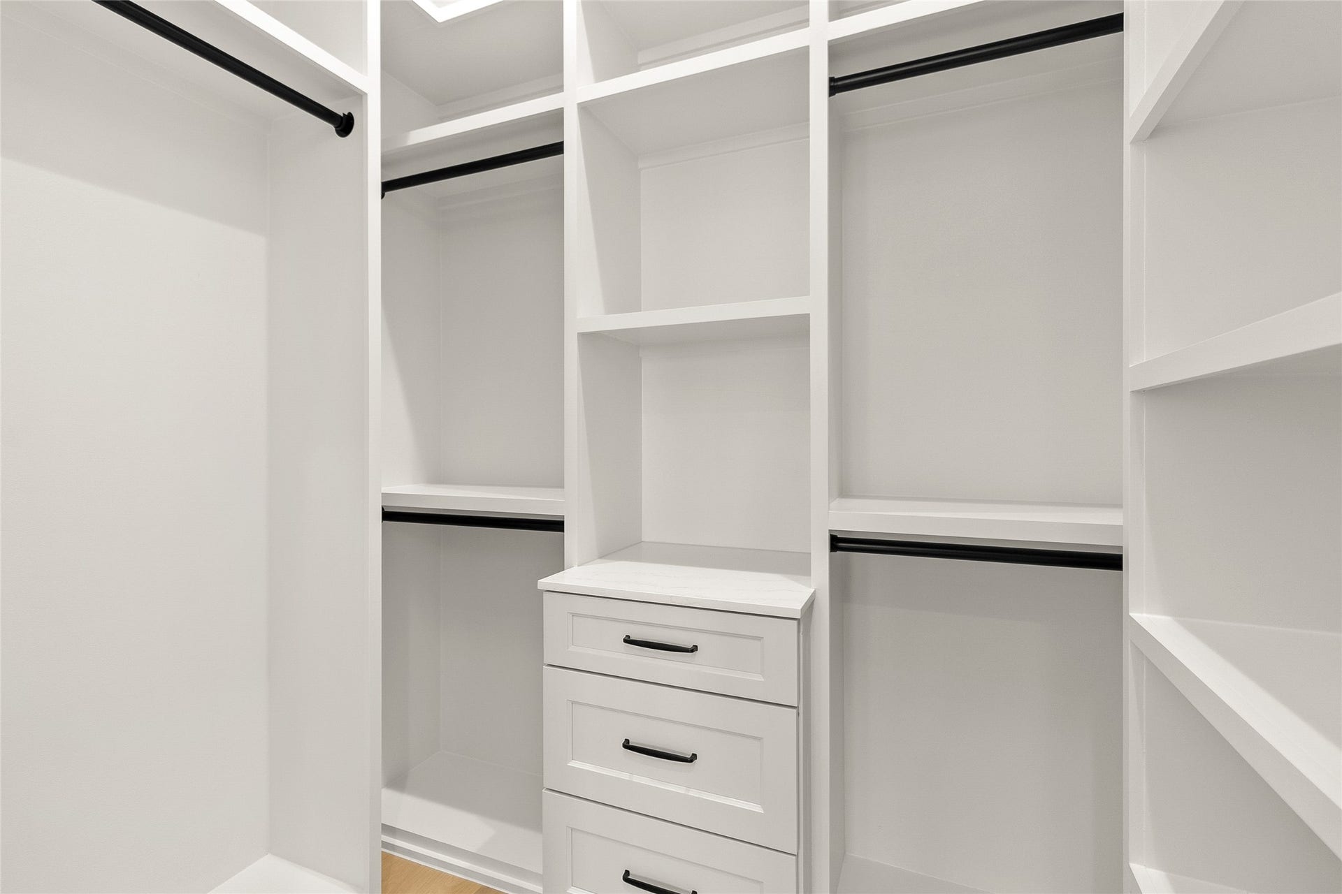 Your custom walk-in closet keeps every wardrobe essential beautifully organized with built-in shelving, drawers, and generous hanging space.