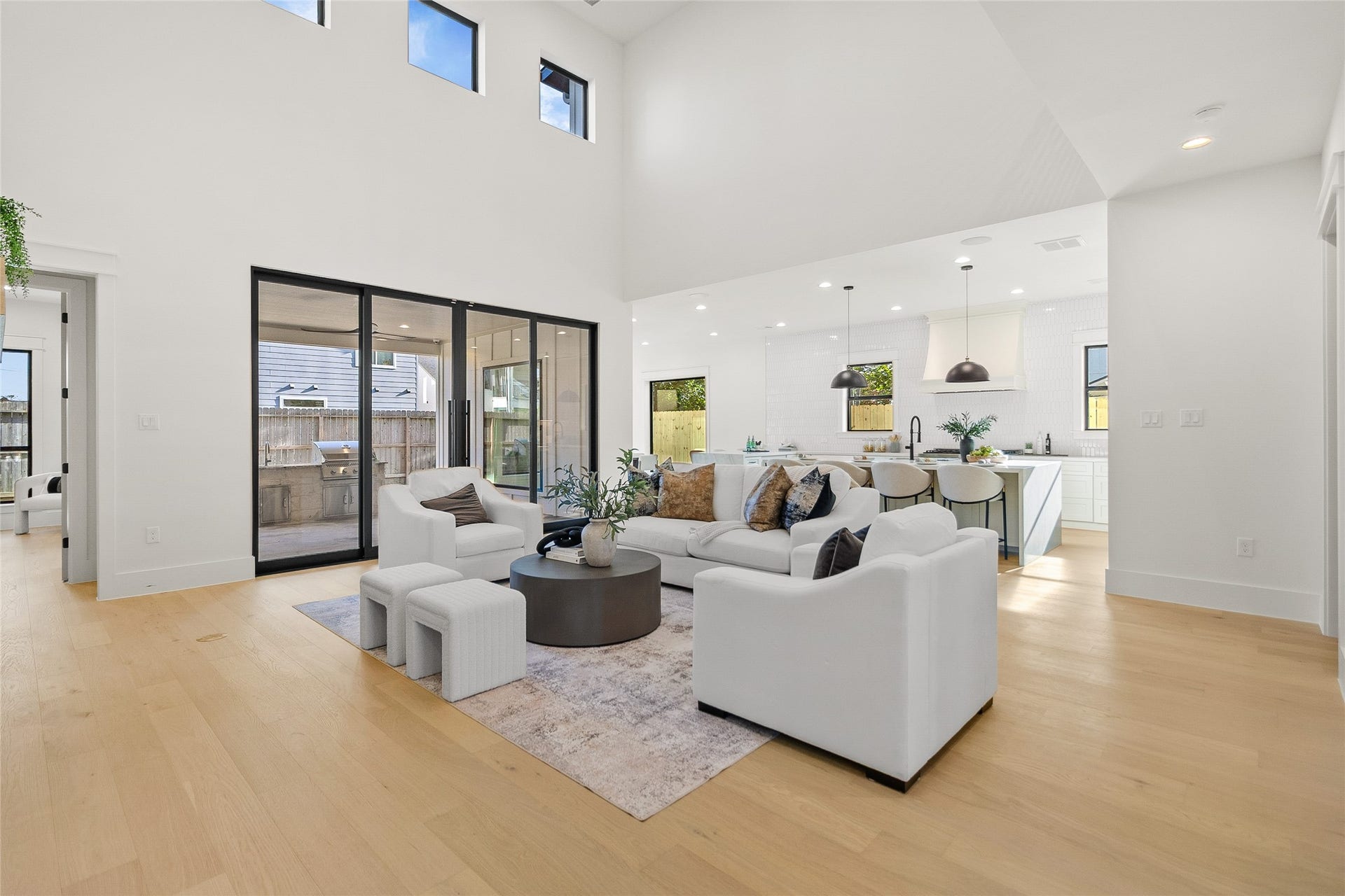 Everyday living feels effortless in this soaring open-concept space, where natural light, seamless indoor-outdoor flow, and designer details create the perfect gathering place.