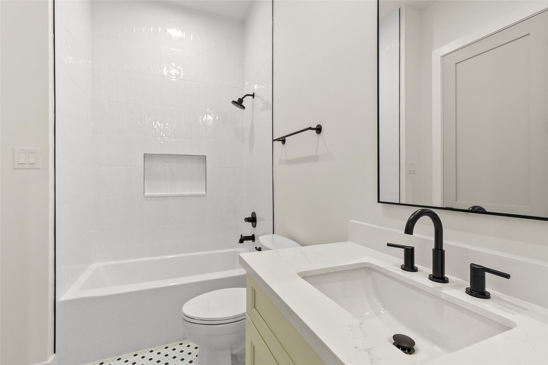 Your secondary bathroom makes mornings easy with a sleek vanity, modern fixtures, and a tub/shower combination perfect for guests or family.