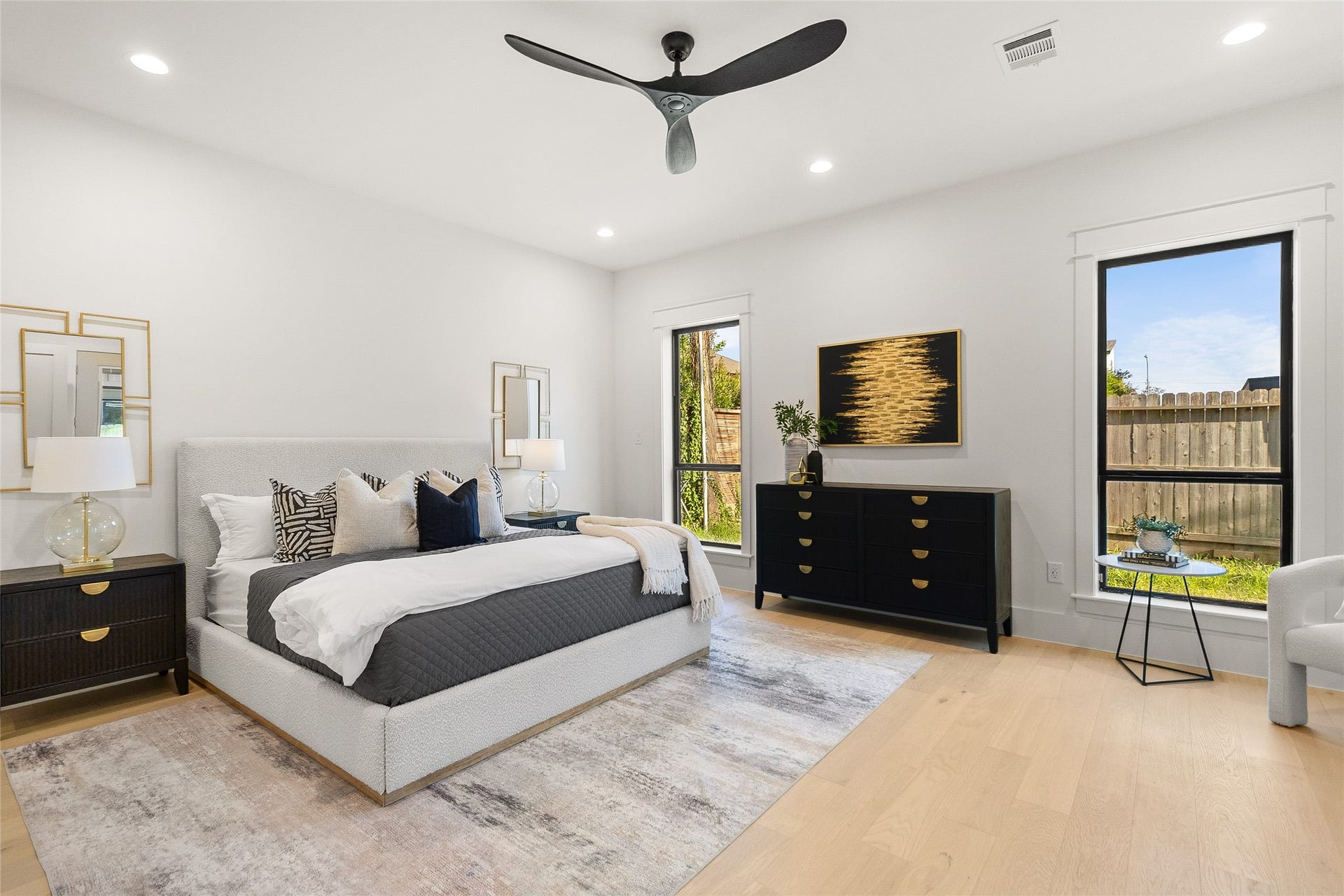 Waking up feels effortless in your spacious primary bedroom, where oversized windows and clean modern finishes create a bright, relaxing escape.