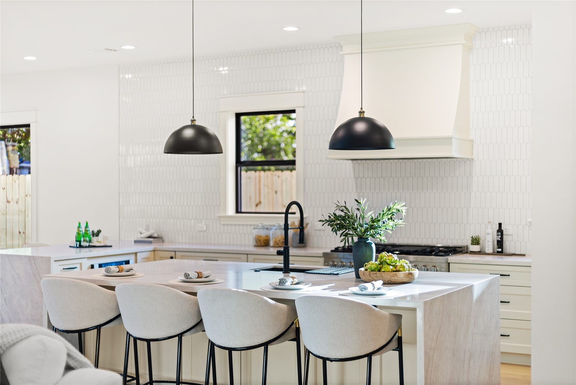 Gathering around the oversized island becomes the heart of every day, where sleek finishes, designer lighting, and generous prep space elevate every occasion.