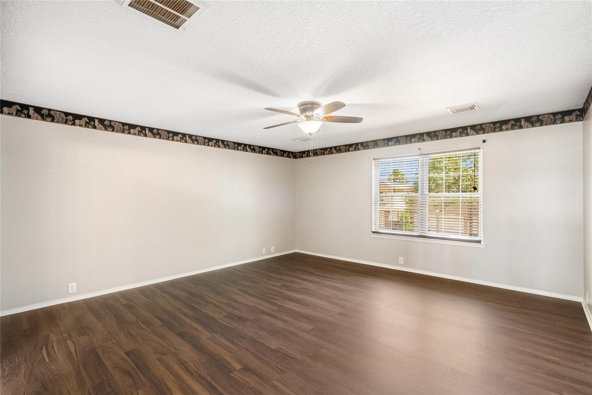 21314 Somerset Park Lane, Katy, TX 77450 The sprawling primary suite has been freshly painted and is equipped with a ceiling fan and a large, bright window!