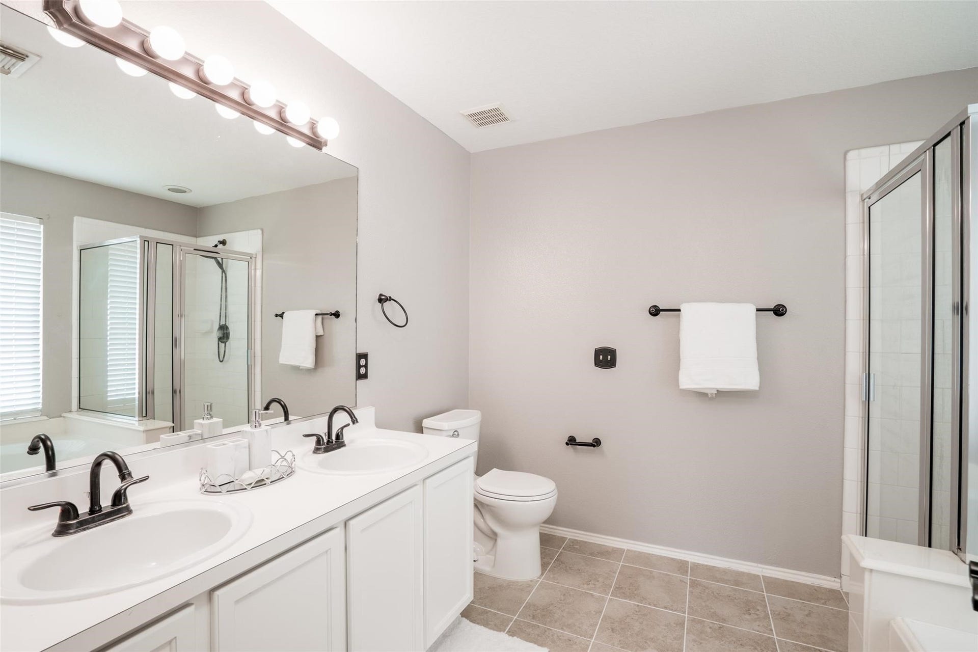 21314 Somerset Park Lane, Katy, TX 77450 The primary bathroom is a retreat with dual sink vanity, large mirror and ceramic tile