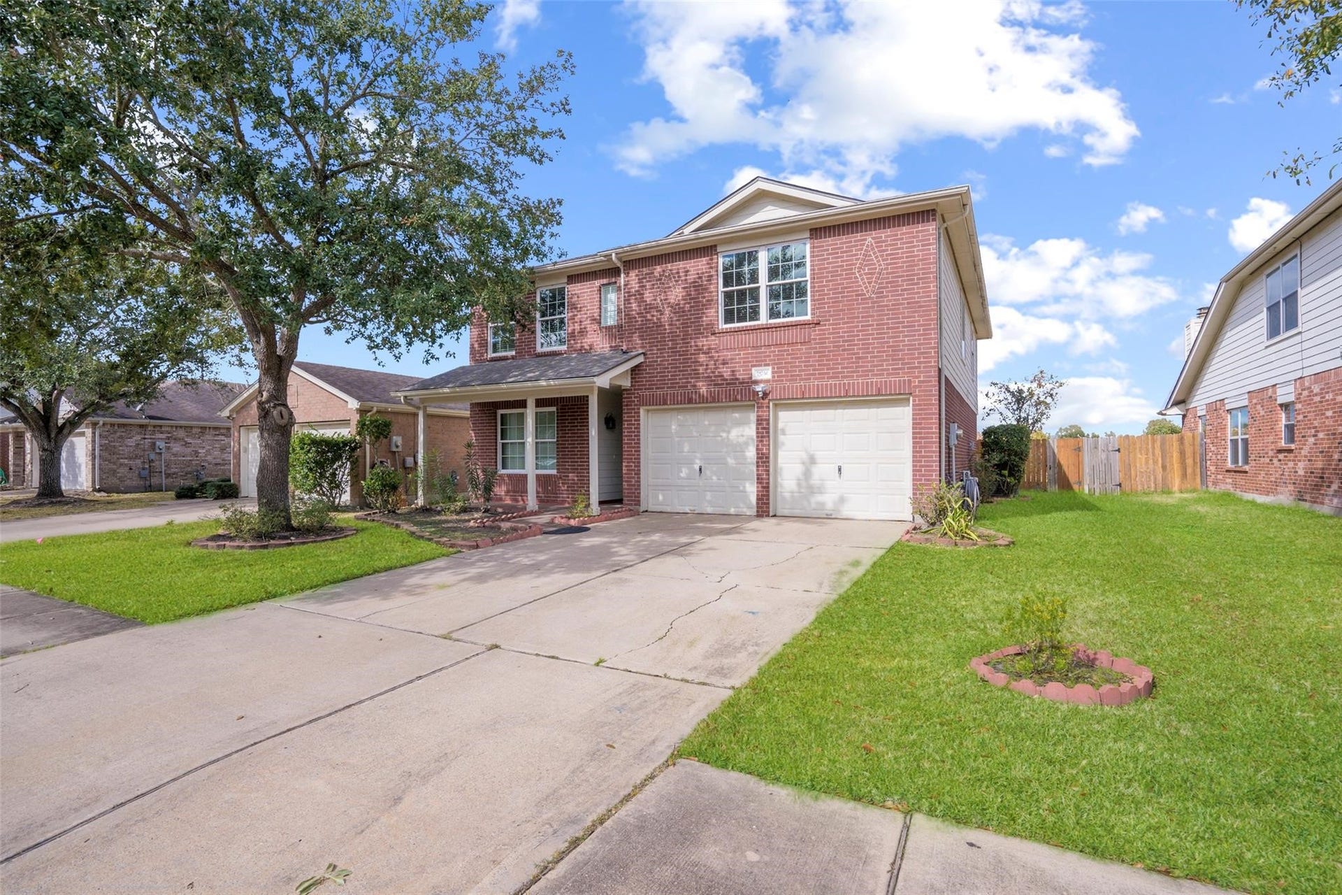 21314 Somerset Park Lane, Katy, TX 77450 Lucious landscaping greets you every day, and the covered porch is the perfect play to relax on the weekends. There is plenty of parking with a two car garage and double driveway! *grass virtually staged