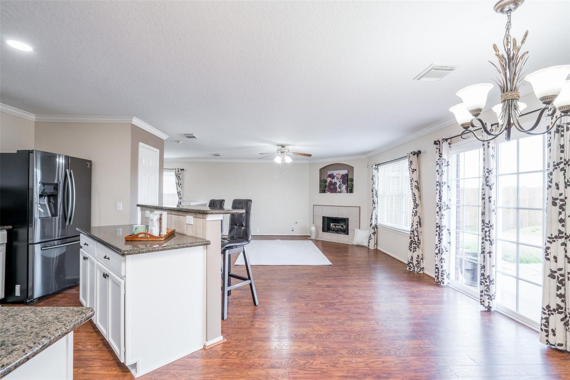 21314 Somerset Park Lane, Katy, TX 77450 A wall of windows offers beautiful views of the backyard, and invites natural light to flow into the main living area of the home.