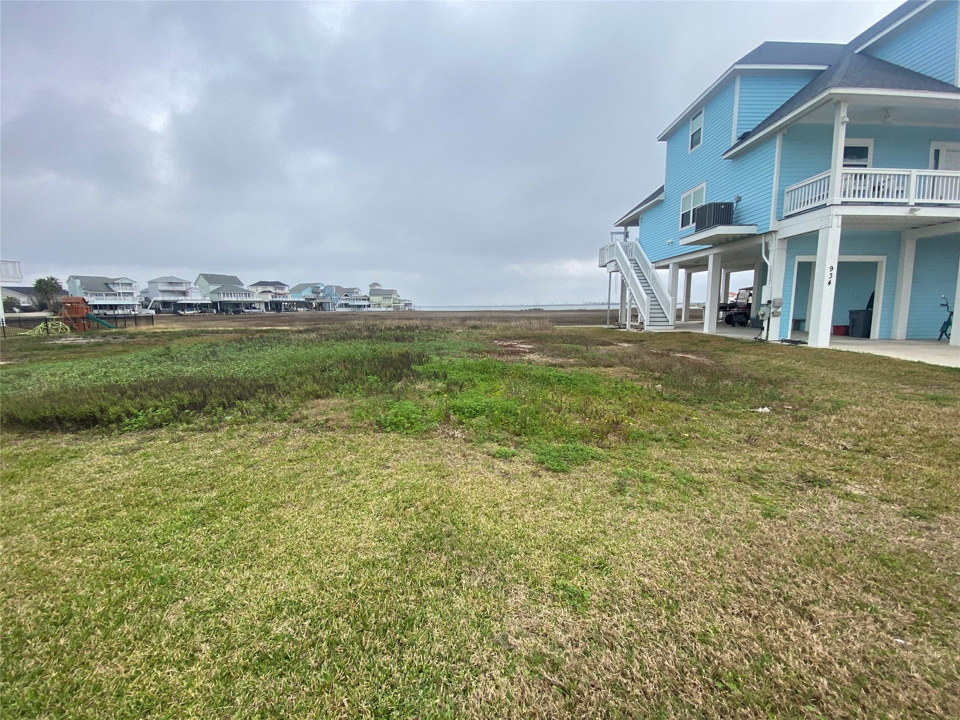 Lot 22 Tiki Drive, Tiki Island, TX 77554 Lot 22 - to the left of the blue house.