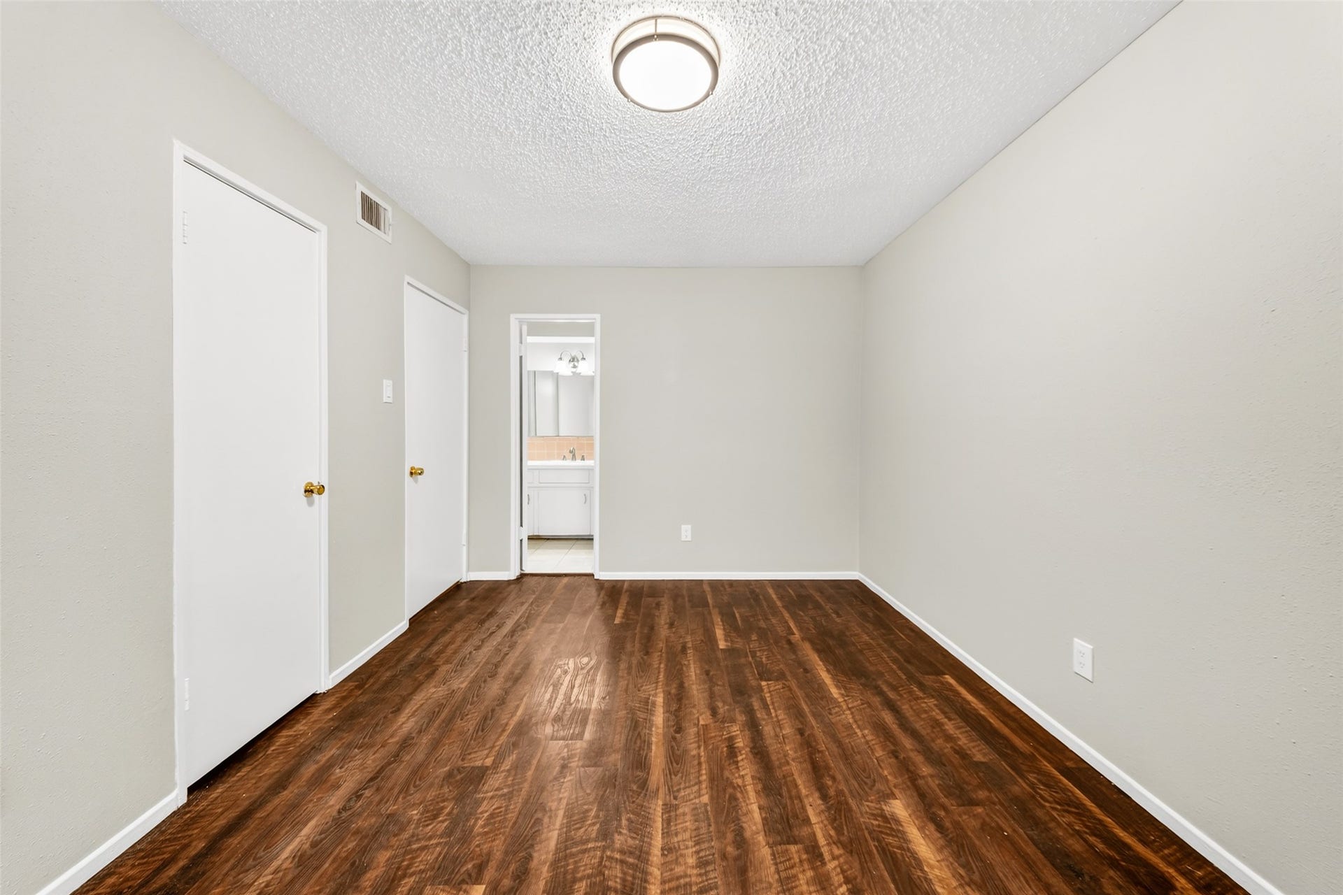 first bedroom connects to bathroom and has generous closet space