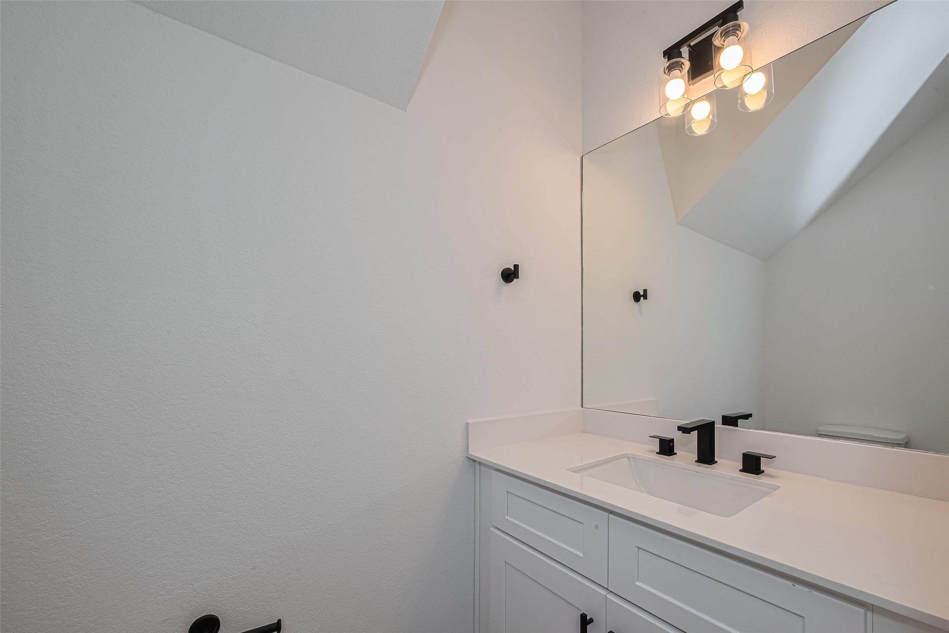 1350 W 24th Street, Houston, TX 77008 Convenient half bathroom with a modern vanity and updated fixtures.