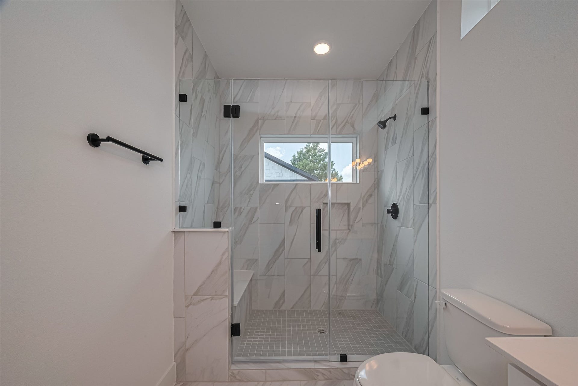 1350 W 24th Street, Houston, TX 77008 Modern bathroom with a glass-enclosed shower and beautiful tile finishes.
