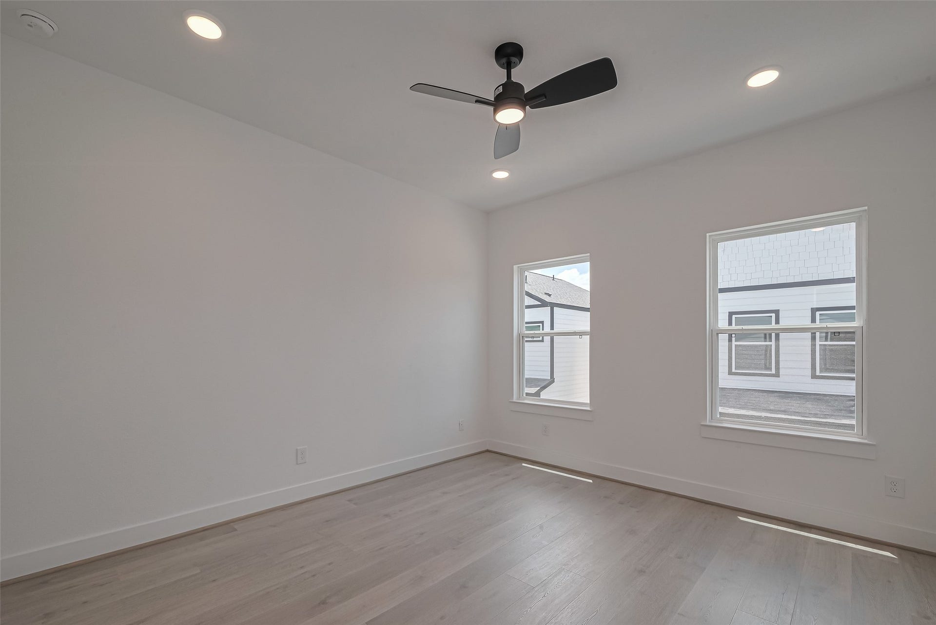 1350 W 24th Street, Houston, TX 77008 Spacious bedroom with a ceiling fan and multiple windows.
