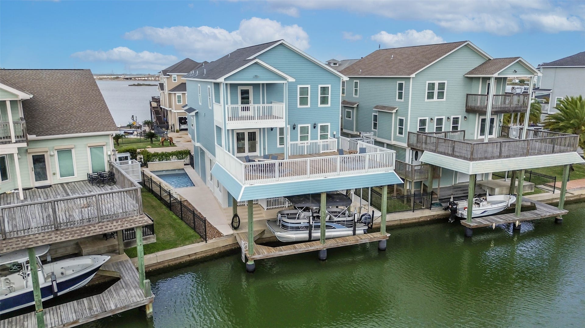 429 Jeanie Lynne Circle, Tiki Island, TX 77554 Elevated construction with covered parking and classic coastal architecture designed for island living.