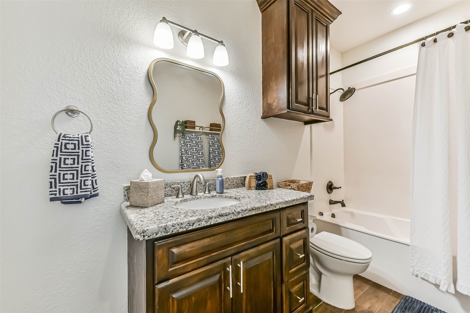 429 Jeanie Lynne Circle, Tiki Island, TX 77554 Adjacent bathroom conveniently located features granite vanity, storage cabinetry, and tub-shower combination.