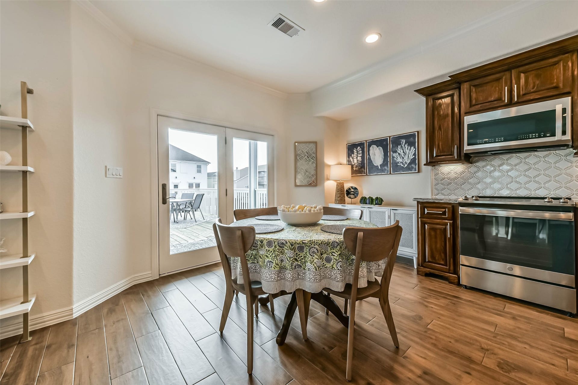 429 Jeanie Lynne Circle, Tiki Island, TX 77554 Charming breakfast space positioned beside double glass doors that open directly to the outdoor patio, creating seamless indoor-outdoor living.