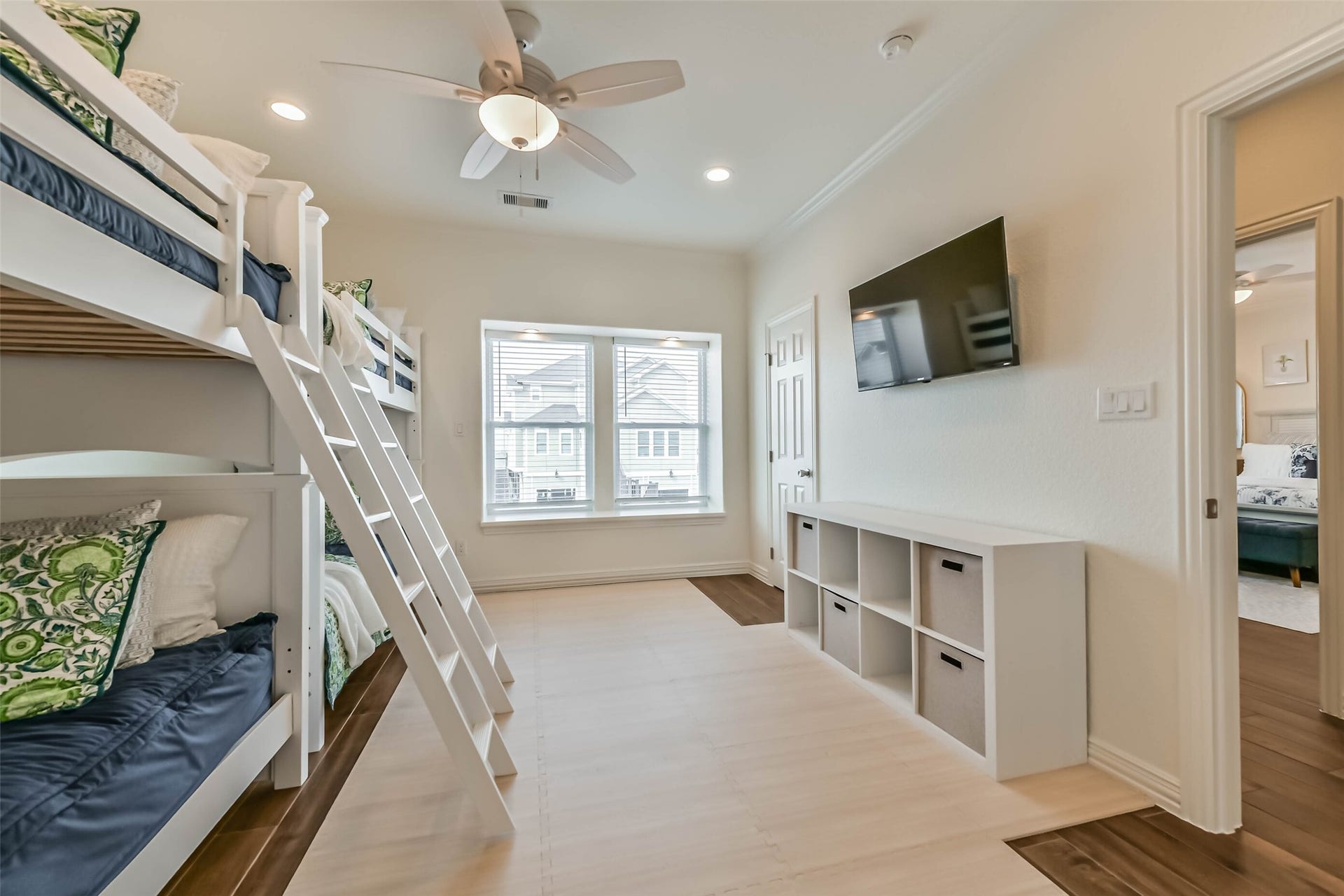 429 Jeanie Lynne Circle, Tiki Island, TX 77554 Well-designed bunk room offers multiple sleeping areas, natural light, and functional storage, ideal for guests or coastal getaways.