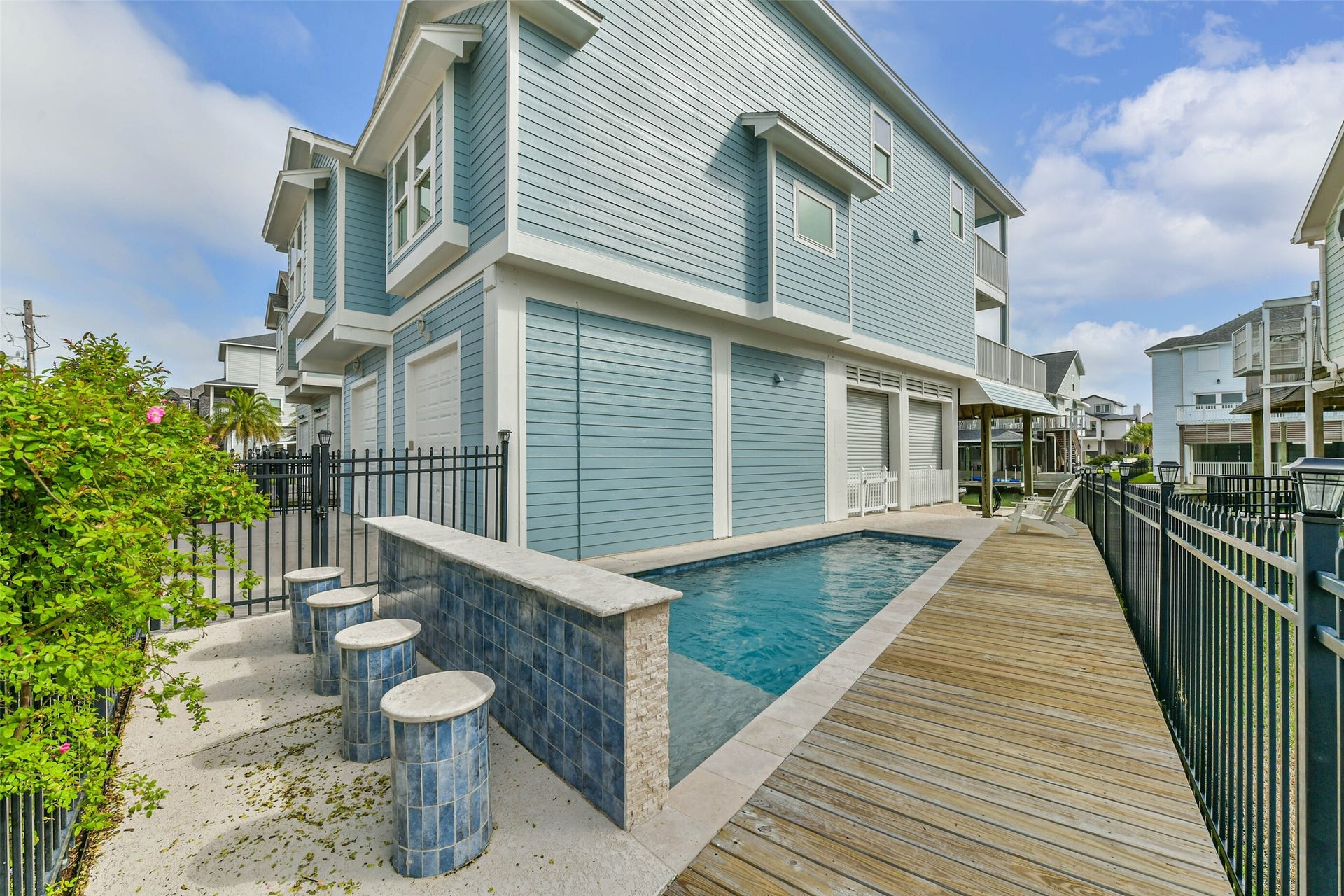 429 Jeanie Lynne Circle, Tiki Island, TX 77554 Private pool designed for relaxation and entertaining, featuring a shallow sun shelf perfect for in-water lounging and enjoying coastal breezes.