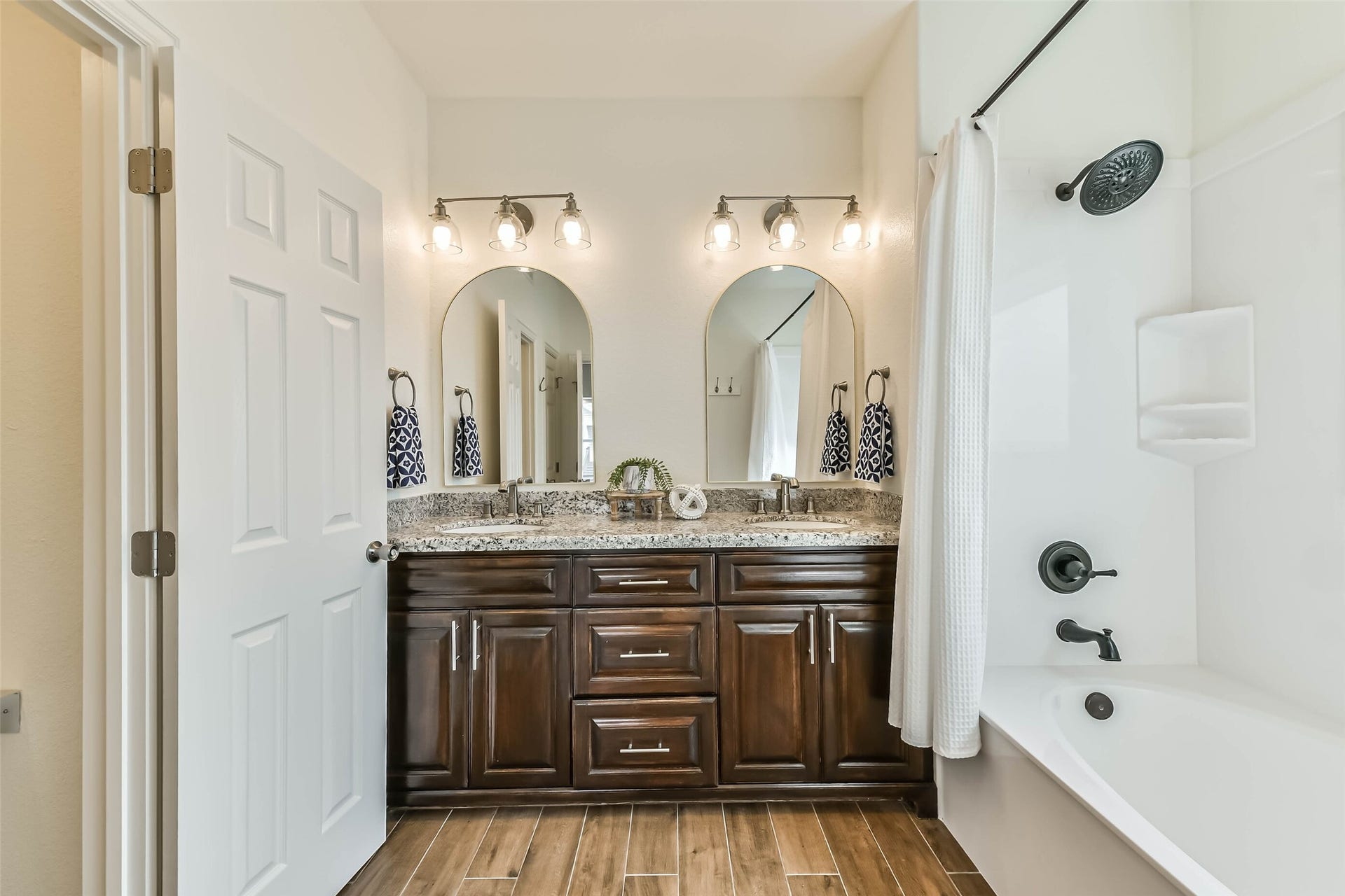 429 Jeanie Lynne Circle, Tiki Island, TX 77554 Spacious guest bath features dual sinks, granite countertops, and ample cabinetry for storage and convenience.