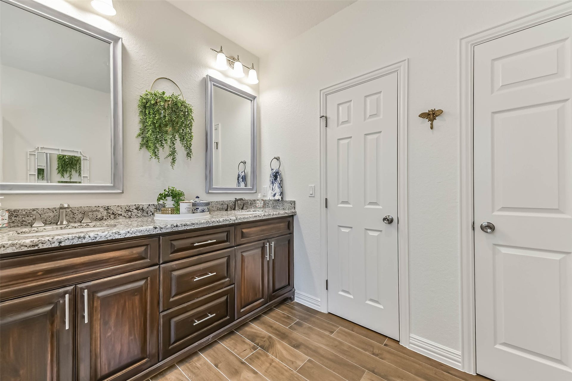 429 Jeanie Lynne Circle, Tiki Island, TX 77554 Well-designed vanity provides plenty of surface space and storage, making shared use convenient for guests or family.