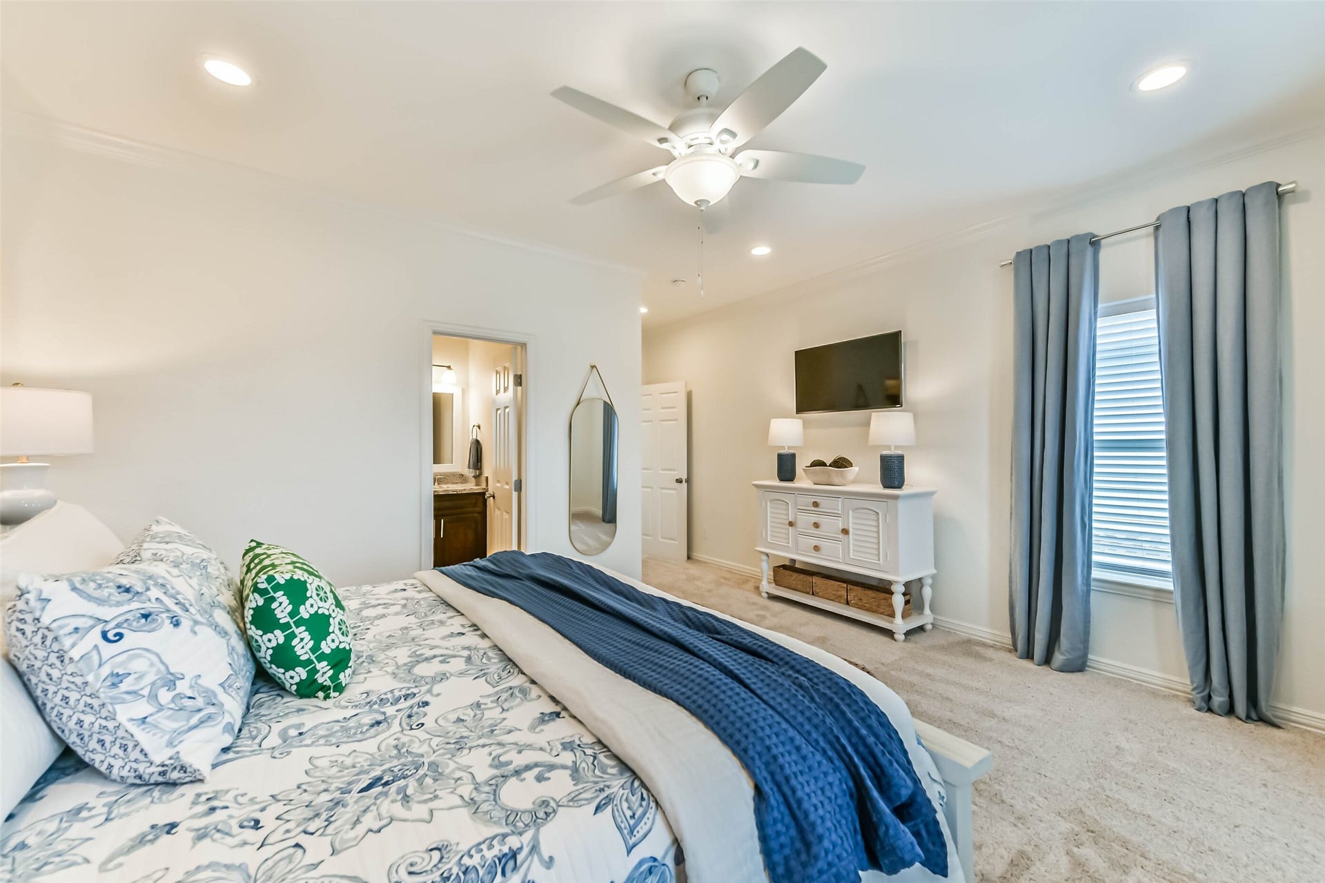 429 Jeanie Lynne Circle, Tiki Island, TX 77554 Comfortable guest bedroom features carpet flooring, ceiling fan, natural light, and coordinated furnishings that convey with the home.