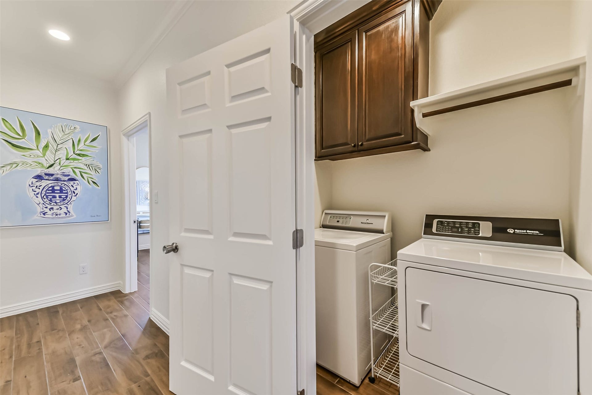 429 Jeanie Lynne Circle, Tiki Island, TX 77554 Convenient laundry area featuring full-size washer and dryer connections, upper cabinetry, and additional storage space.