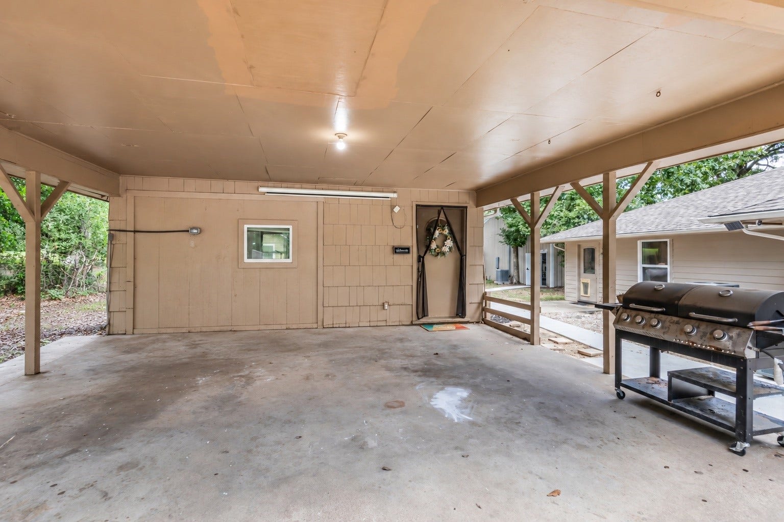 Covered carport and entry to the garage apartment