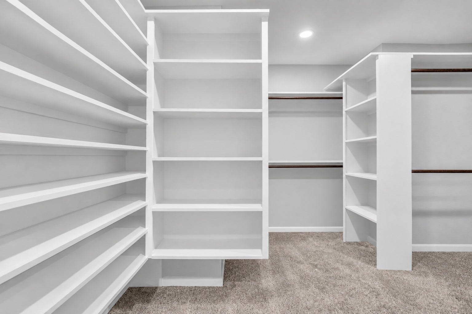 Walk in primary closet with built in shelves