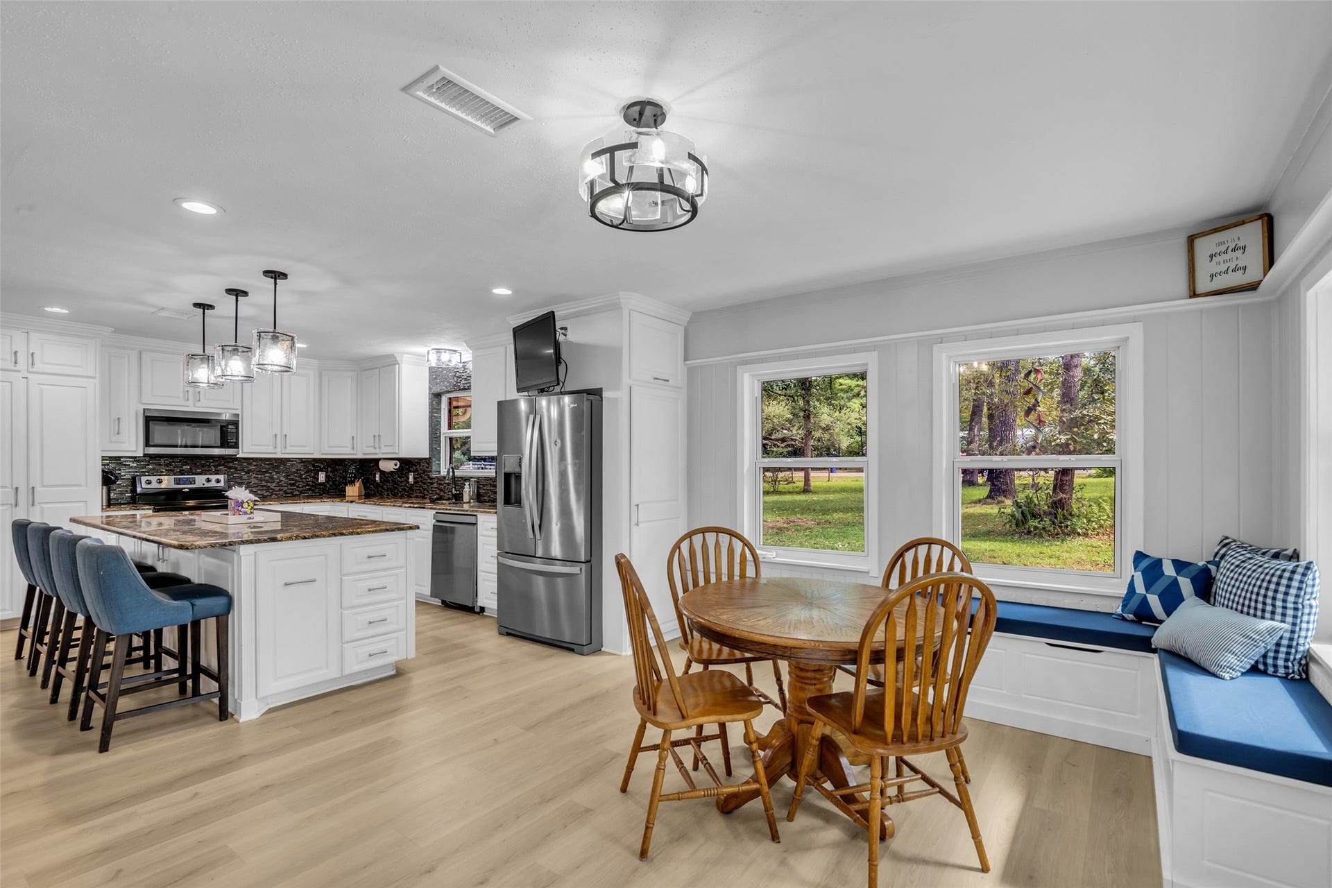 Dining area just off the kitchen, with windows framing peaceful views of the property