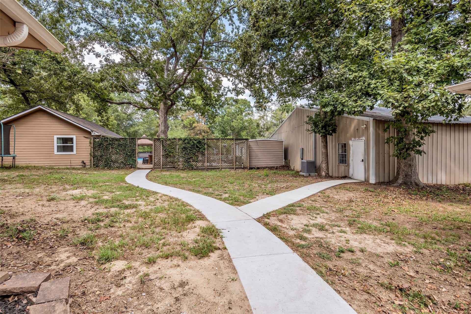 walk way leading to pool are other building on property