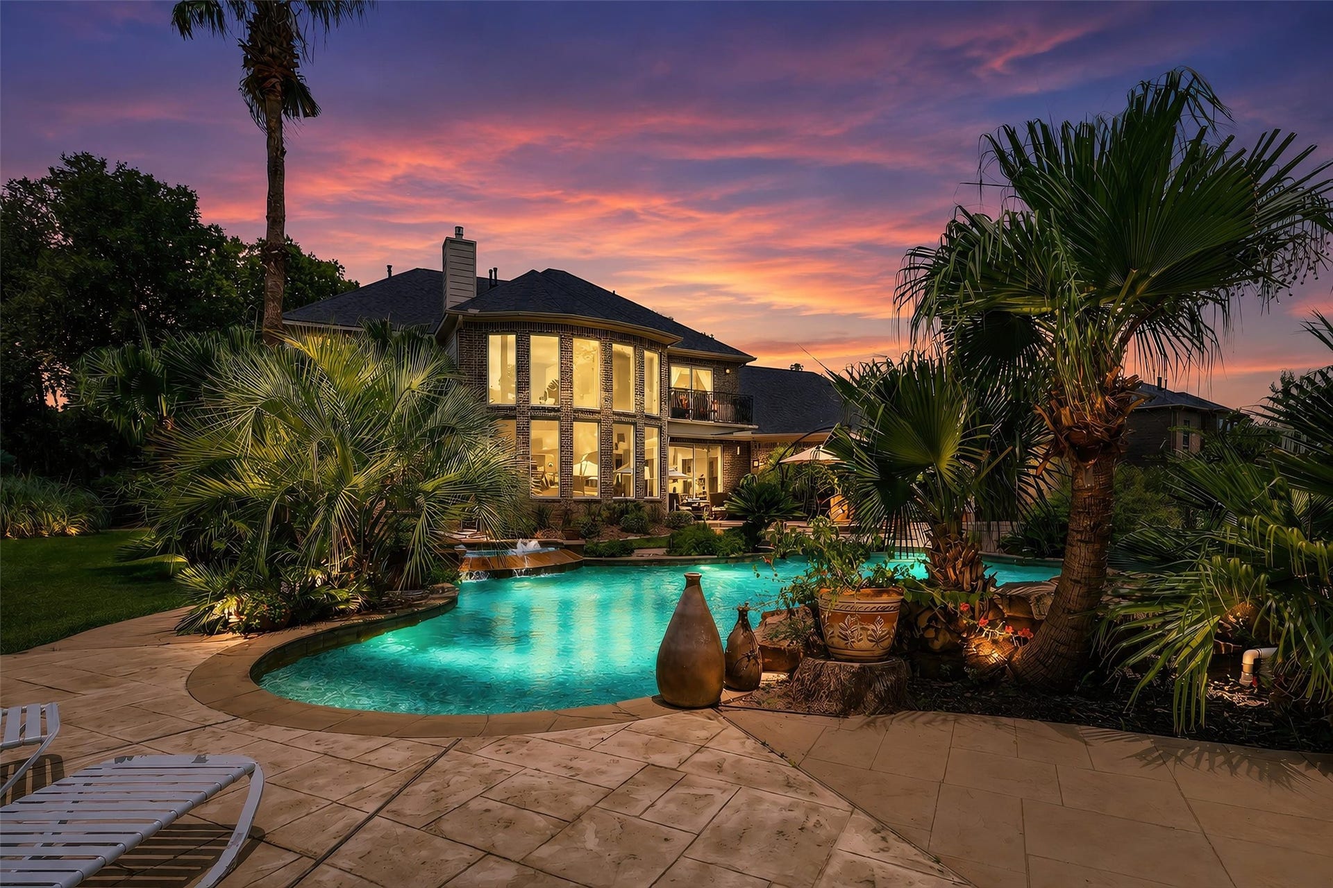 Located in Weston Lakes, a spectacular resort-style oasis awaits, complete with a sparkling pool and spa, expansive covered patio, and summer kitchen, an idyllic setting for elegant entertaining, alfresco dining, and year-round relaxation.