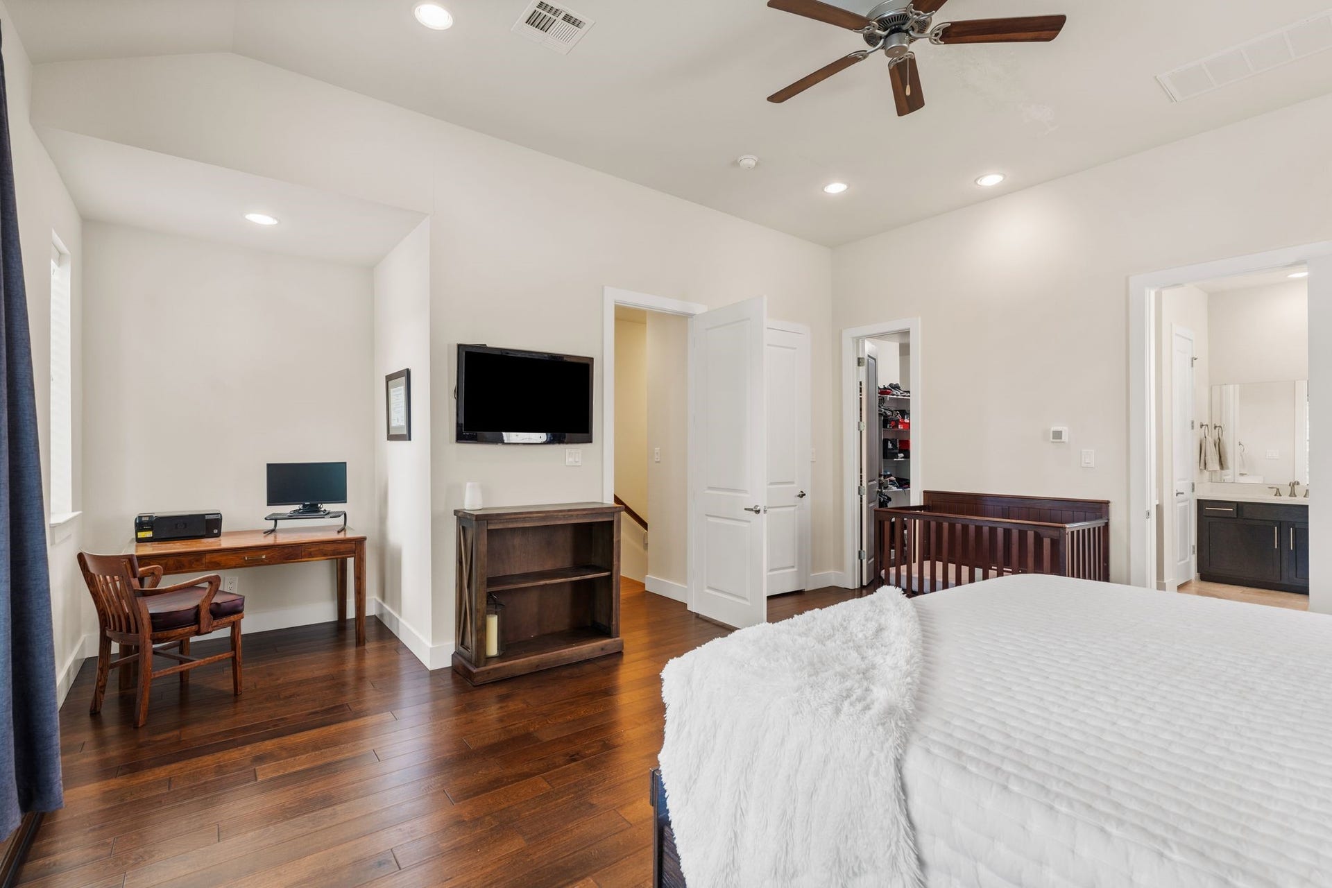 This space features high ceilings and a clever alcove that could easily serve as a secondary workspace, a peaceful reading nook, or a morning coffee station.