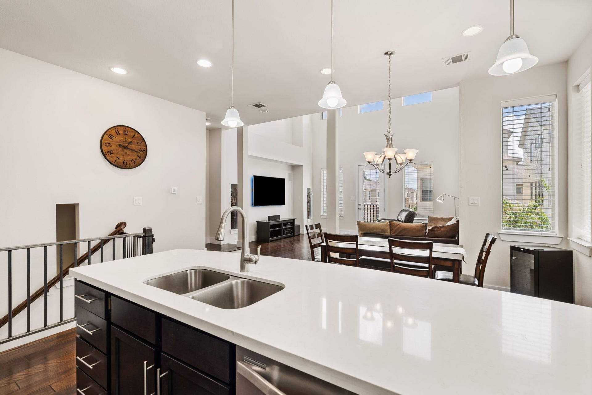 The massive windows flood the space with natural light, highlighting the clean lines and sophisticated finishes while blurring the boundaries between each zone.