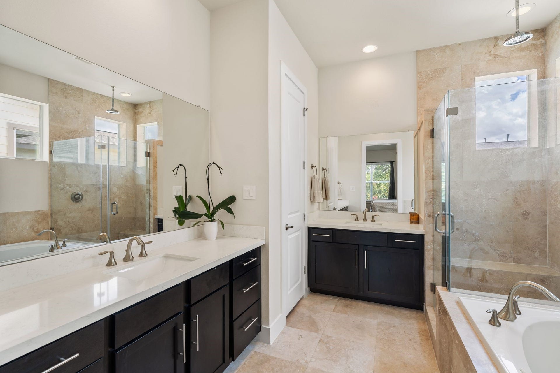 There is no shortage of space with dual separate vanities, and premium quartz countertops. Indulge in a deep jetted tub for unwinding, and a separate glass-enclosed shower.