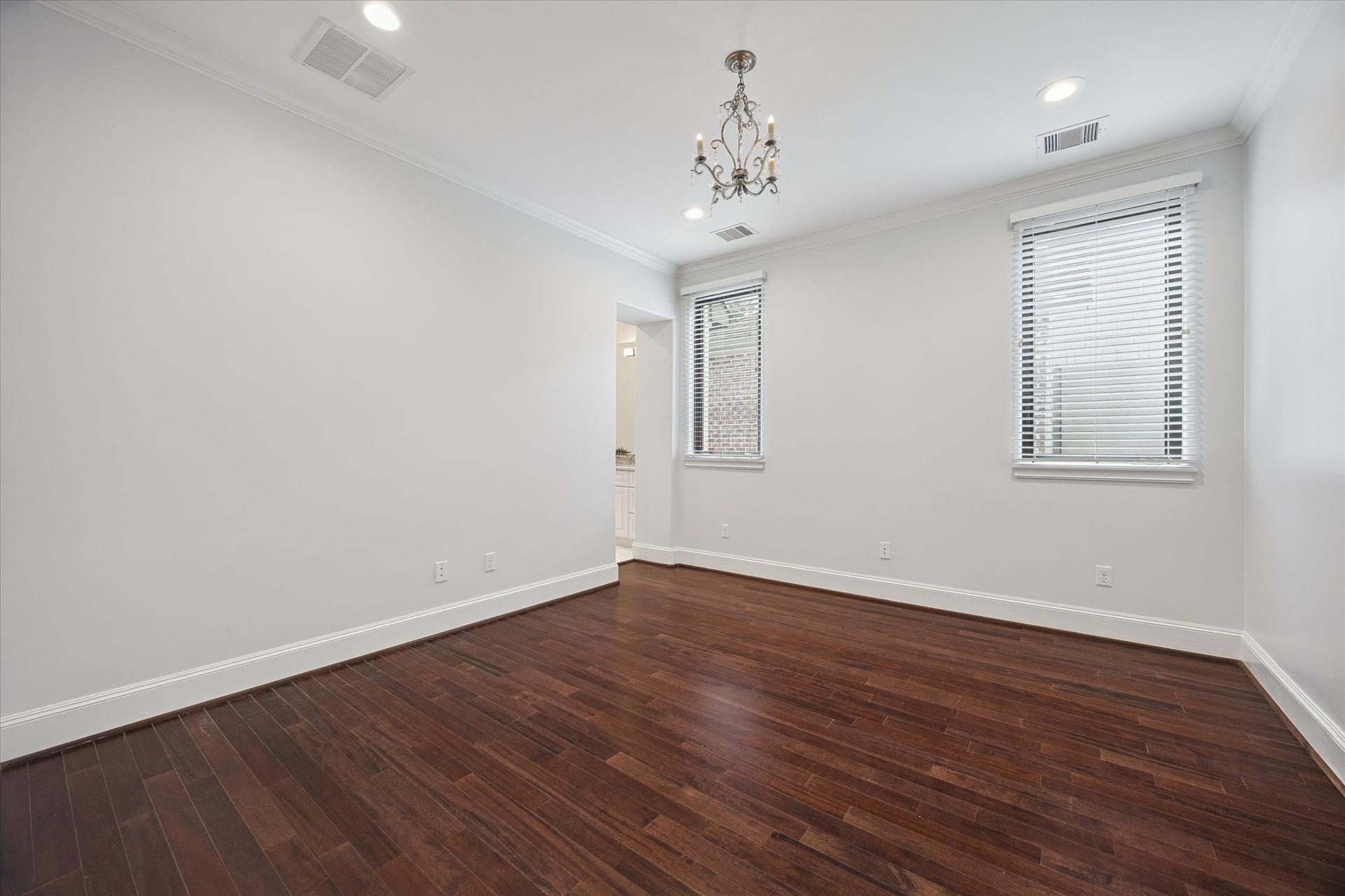 4022 Coleridge Street, West University Place, TX 77005 Bright secondary bedroom with hardwood flooring, large windows, and ample space for guests or family.