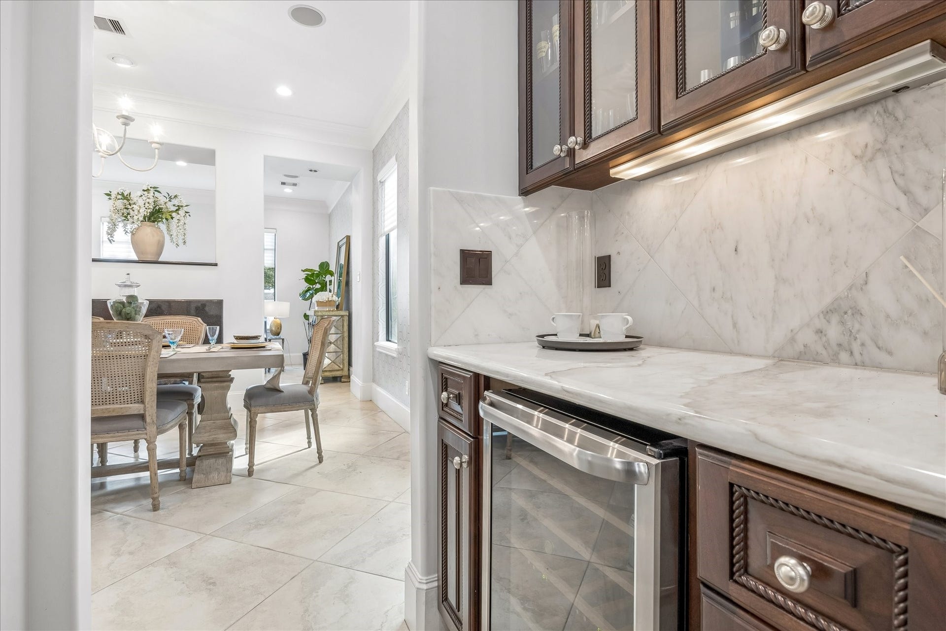 4022 Coleridge Street, West University Place, TX 77005 Built-in beverage refrigerator with coffee station. Marble backsplash and countertops complete with wine storage. Perfect for entertaining and hosting events.