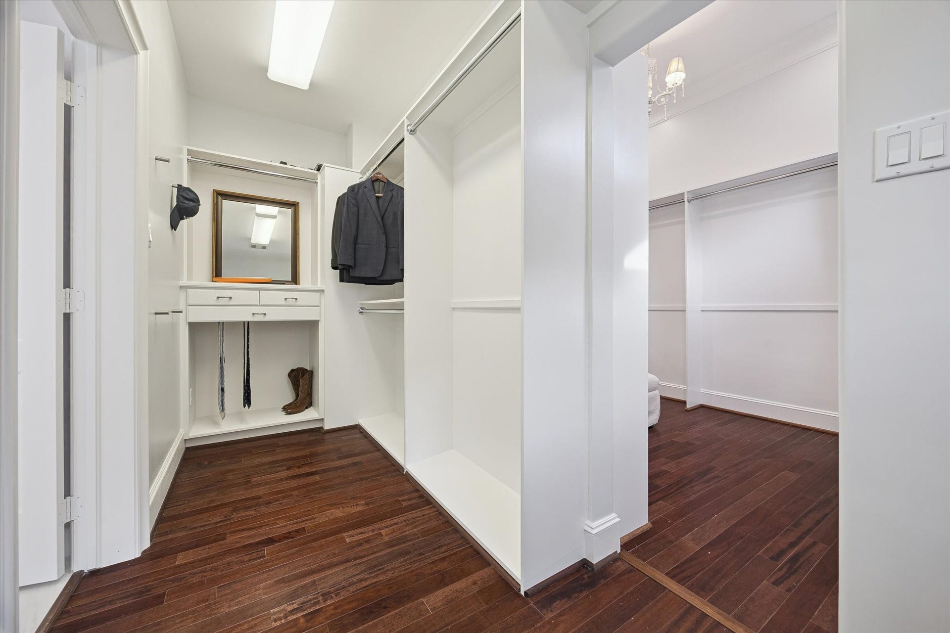 4022 Coleridge Street, West University Place, TX 77005 Spacious walk-in primary closet featuring custom built-ins, drawer storage, and hanging space with rich hardwood flooring - Wraps around to another closet space room!