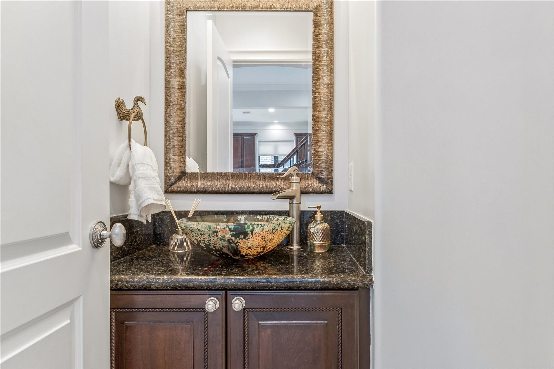 4022 Coleridge Street, West University Place, TX 77005 Stylish powder bath featuring a decorative vessel sink, granite counter, and designer fixtures.