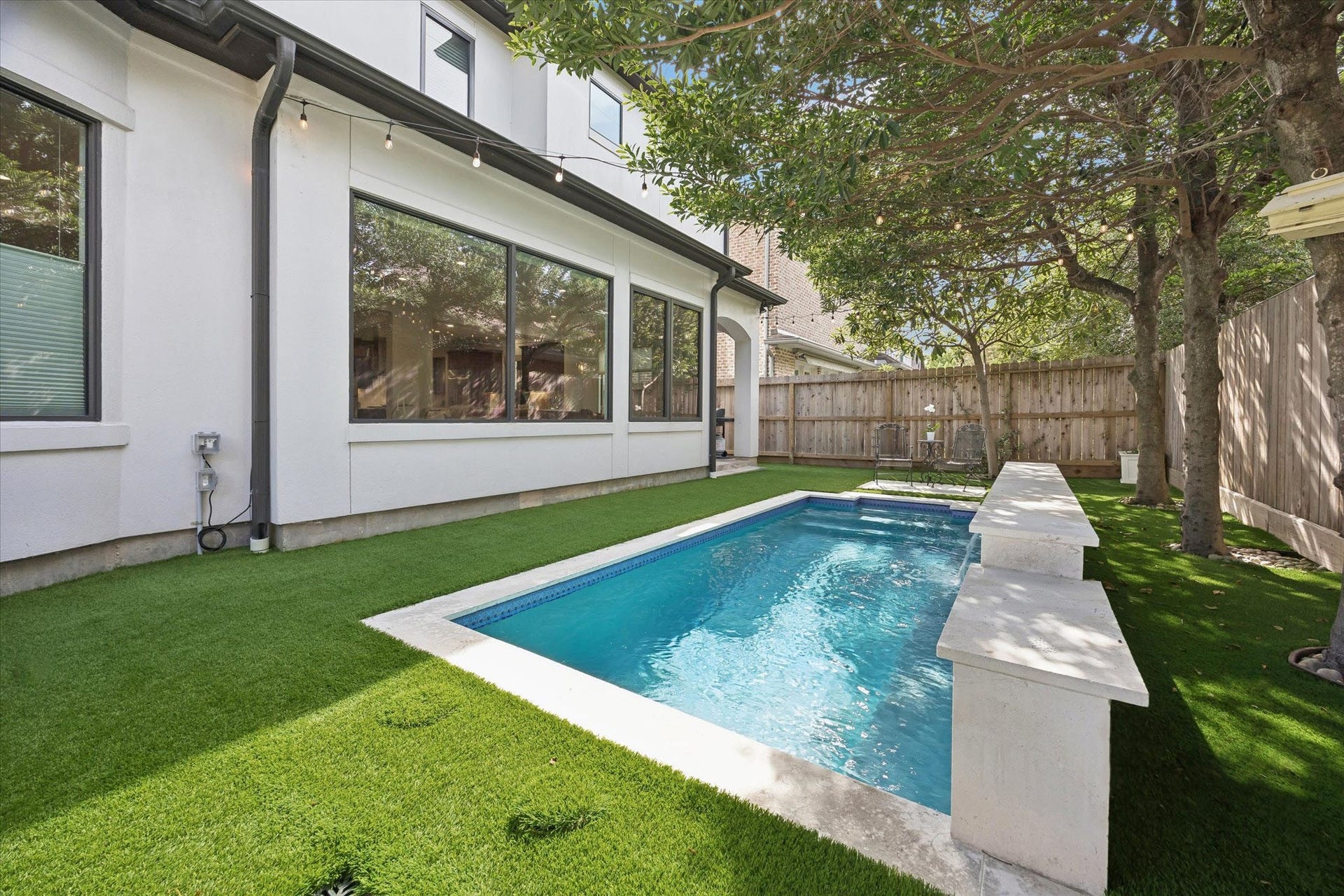 4022 Coleridge Street, West University Place, TX 77005 Another view of this tranquil backyard and fully automated, heated pool, revealing the convenient covered patio space adjacent to the living room and breakfast room.