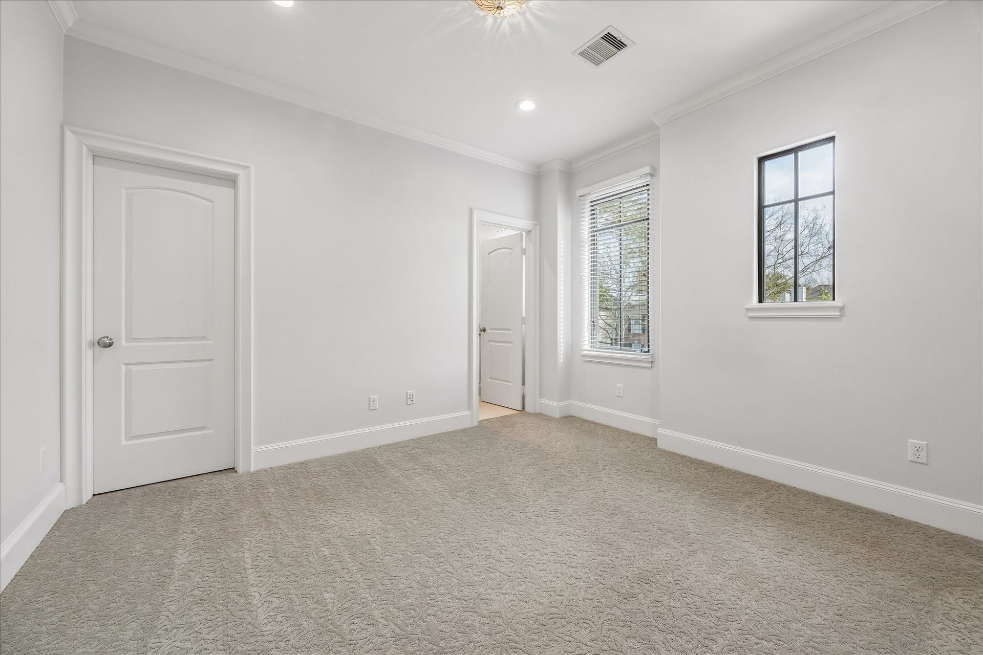 4022 Coleridge Street, West University Place, TX 77005 Bright secondary bedroom featuring plush designer carpet, crown molding, and oversized windows with walk-in closet and private bathroom.