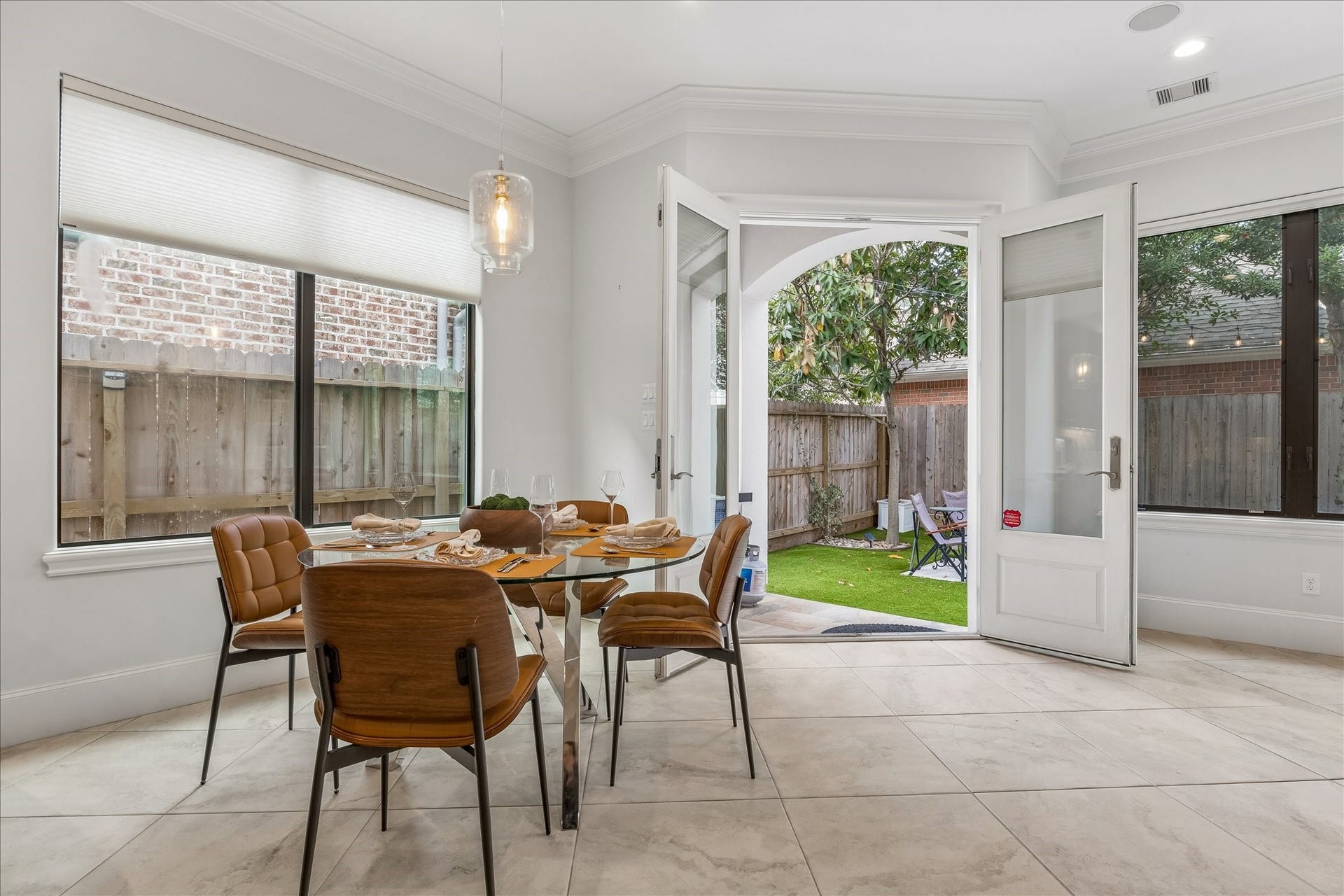 4022 Coleridge Street, West University Place, TX 77005 Light-filled breakfast nook with modern lighting and French doors opening to the private backyard patio.