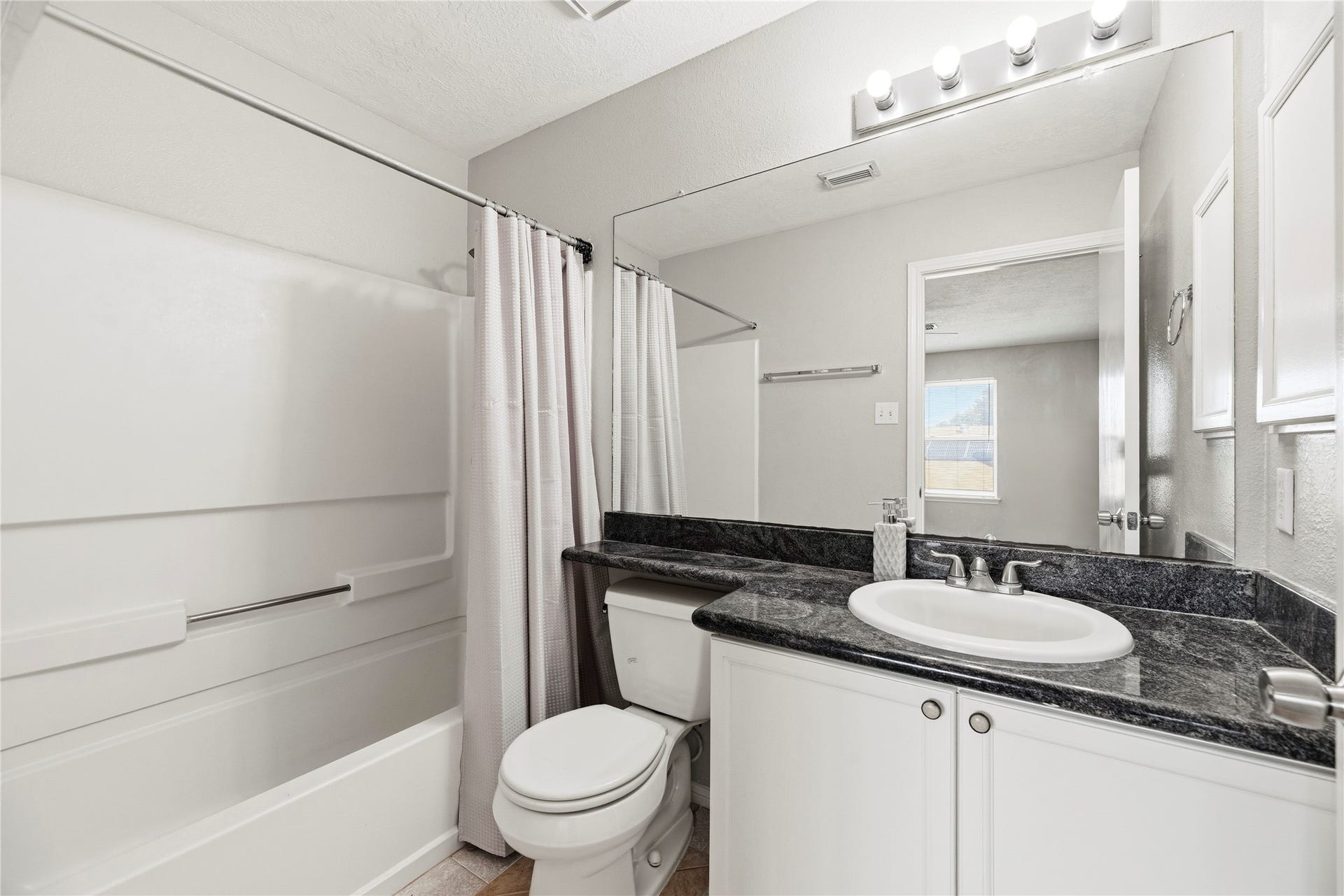 18502 Bridoon Drive, Cypress, TX 77433 Upstairs full bathroom with a tub/shower combination.