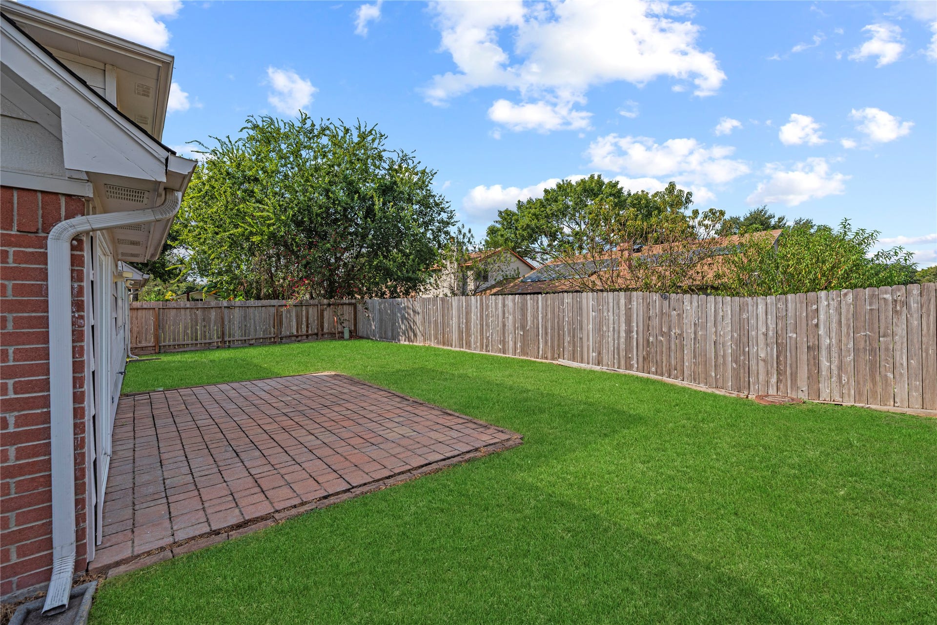 18502 Bridoon Drive, Cypress, TX 77433 Step outside to a private backyard with a patio area. Grass has been digitally enhanced to show potential.