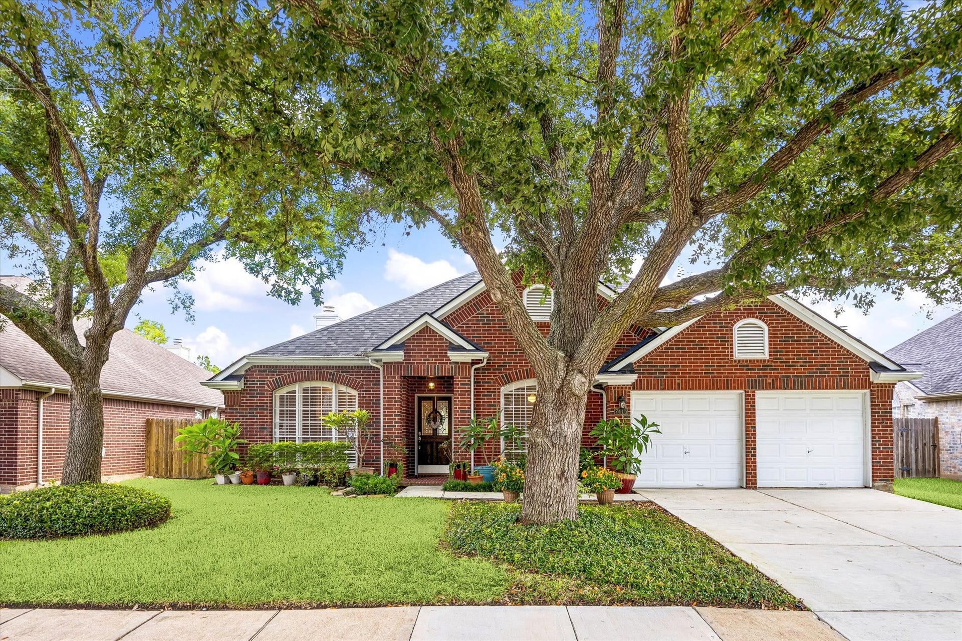 7415 ORCHARD HILLS LANE, Sugar Land, TX 77479 MATURE TREES FRAME THE FRONT OF THIS BRICK HOME IN GREATWOOD CROSSING, WITH A TWO-CAR GARAGE AND WELL-ESTABLISHED LANDSCAPING.